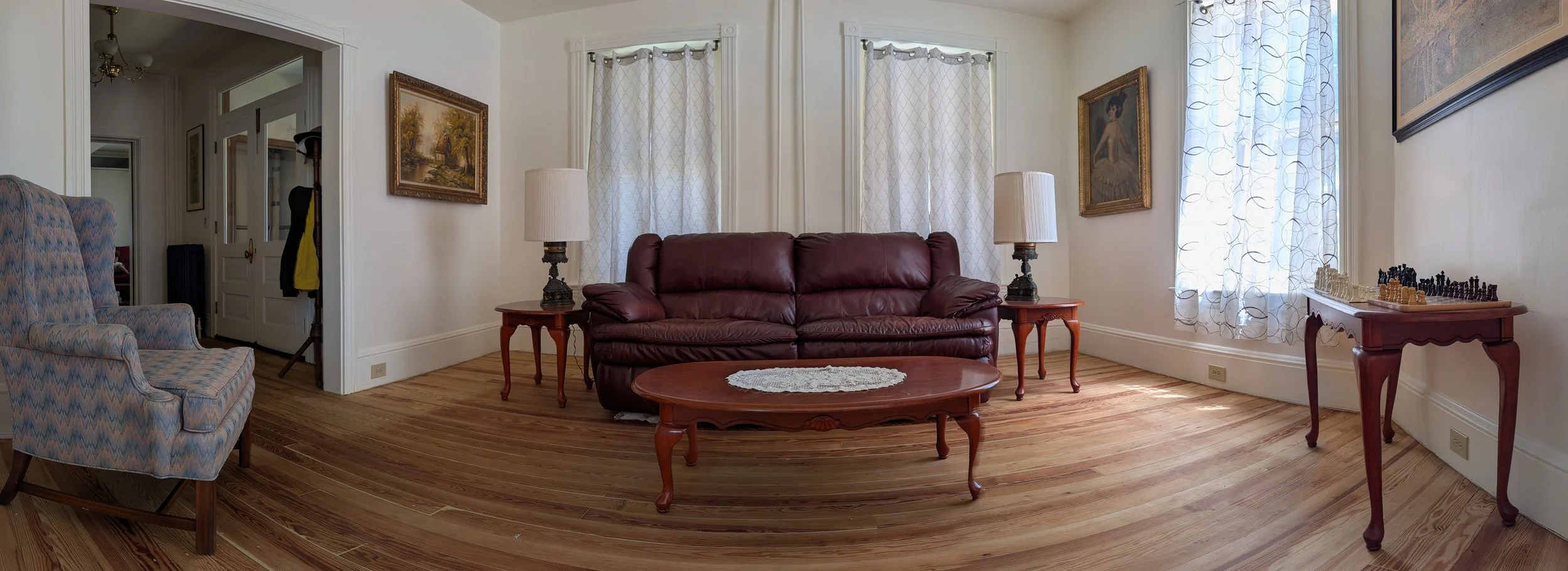 Historic guest sitting room at Bella Vista Bed and Breakfast featuring elegant seating, original hardwood floors, abundant natural light, and a welcoming space to relax in Akron, Pennsylvania.
