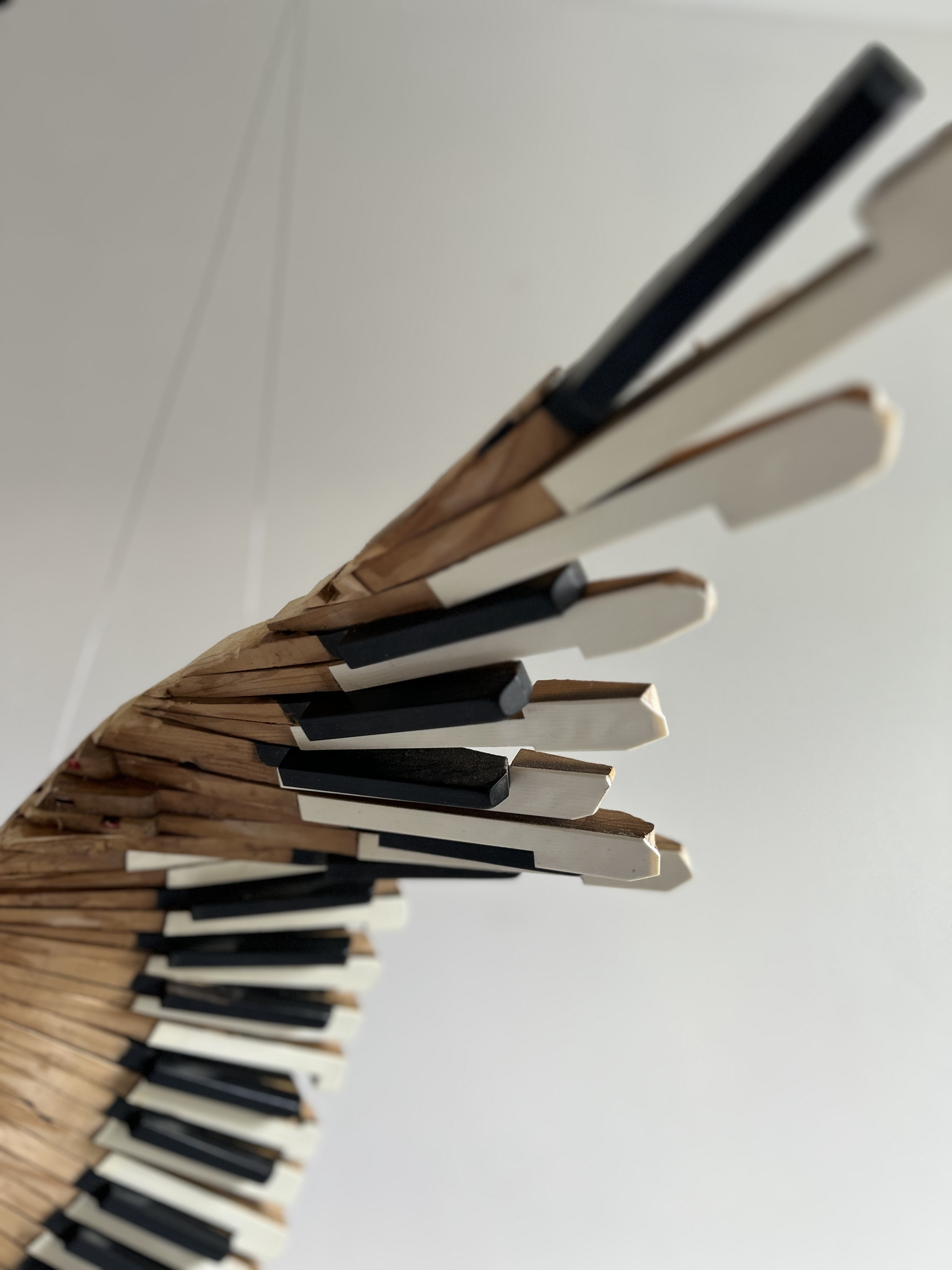 Wing detail of Red Kite sculpture made from piano parts.