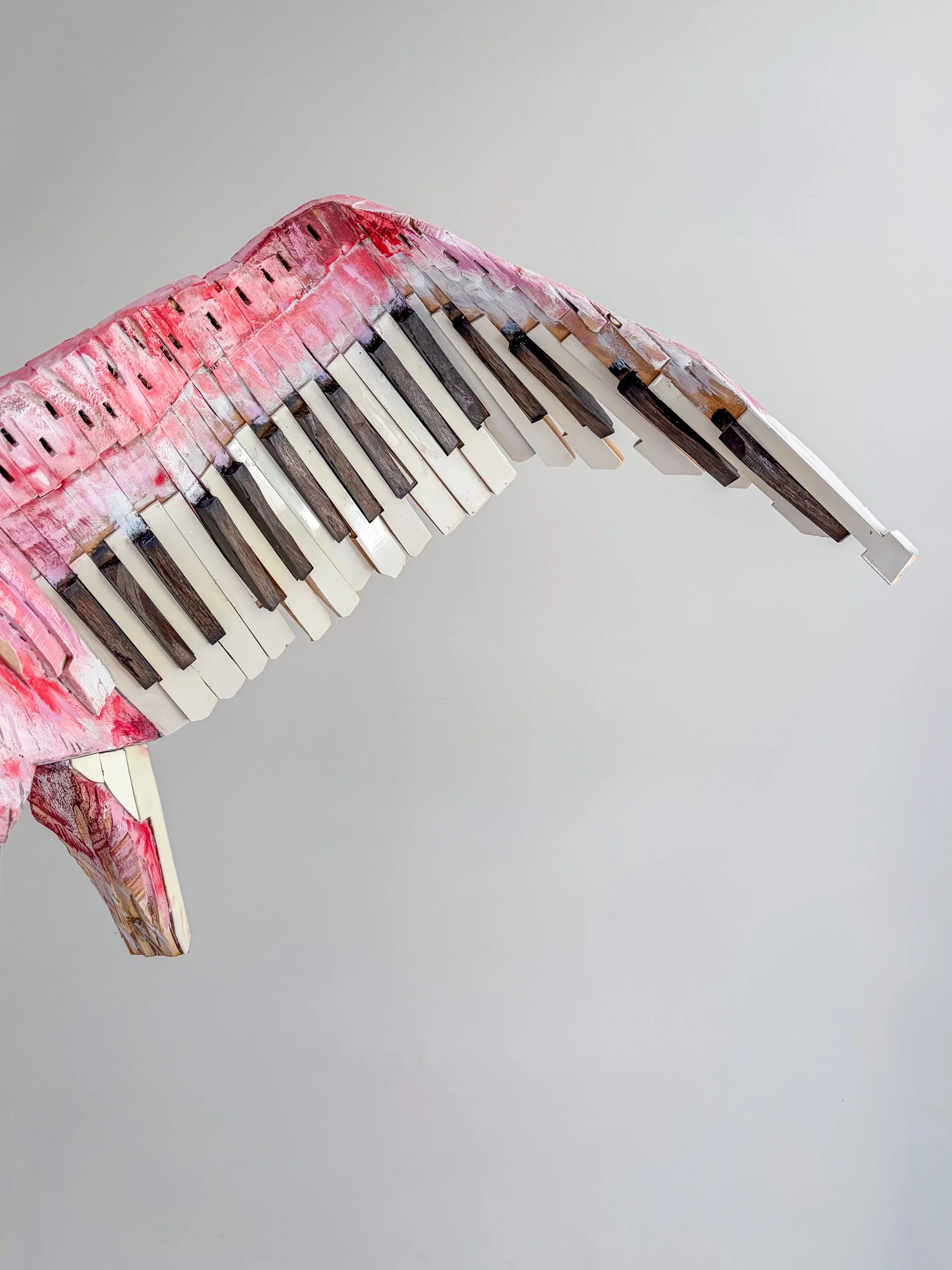 Roseate Spoonbill sculpture made from piano parts shown with close up of wing detail.