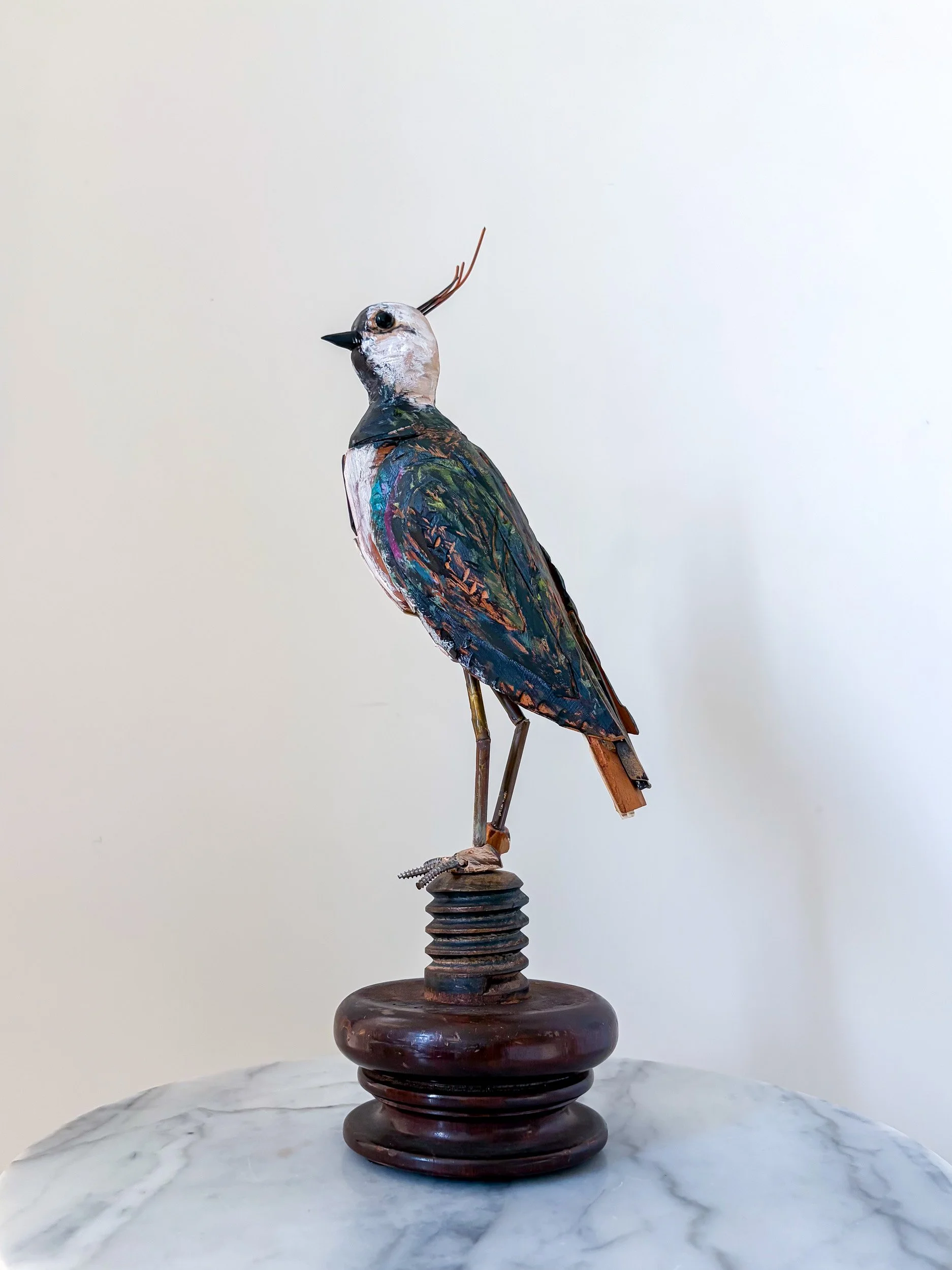 Northern Lapwing sculpture made from piano parts, shown in side profile.