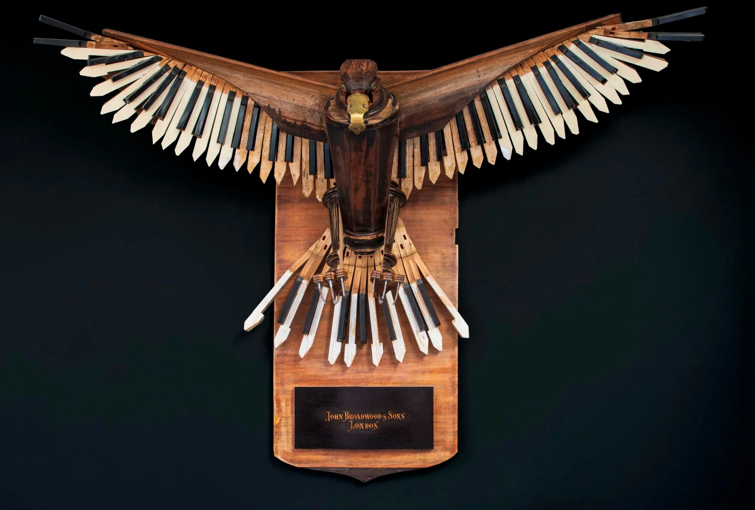 A golden eagle sculpture made from piano parts by Marc Hackworthy.