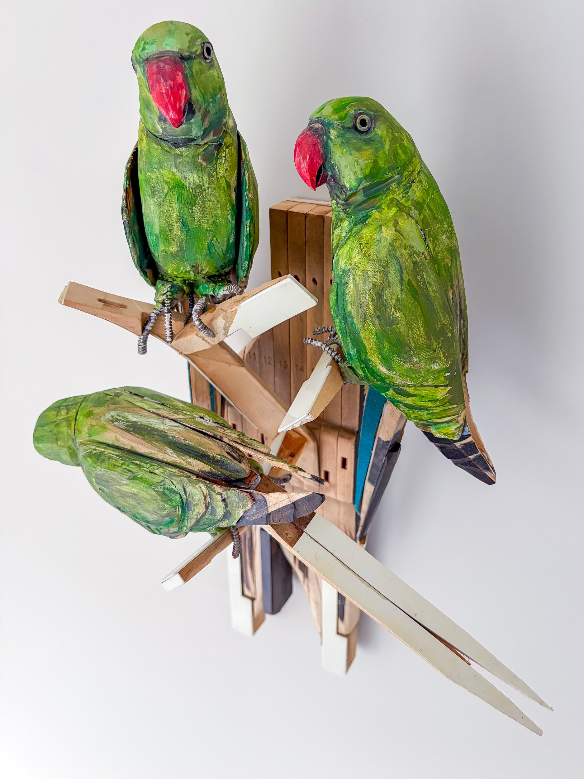 Sculpture of Three Parakeets in F Minor made of piano parts shown from above.