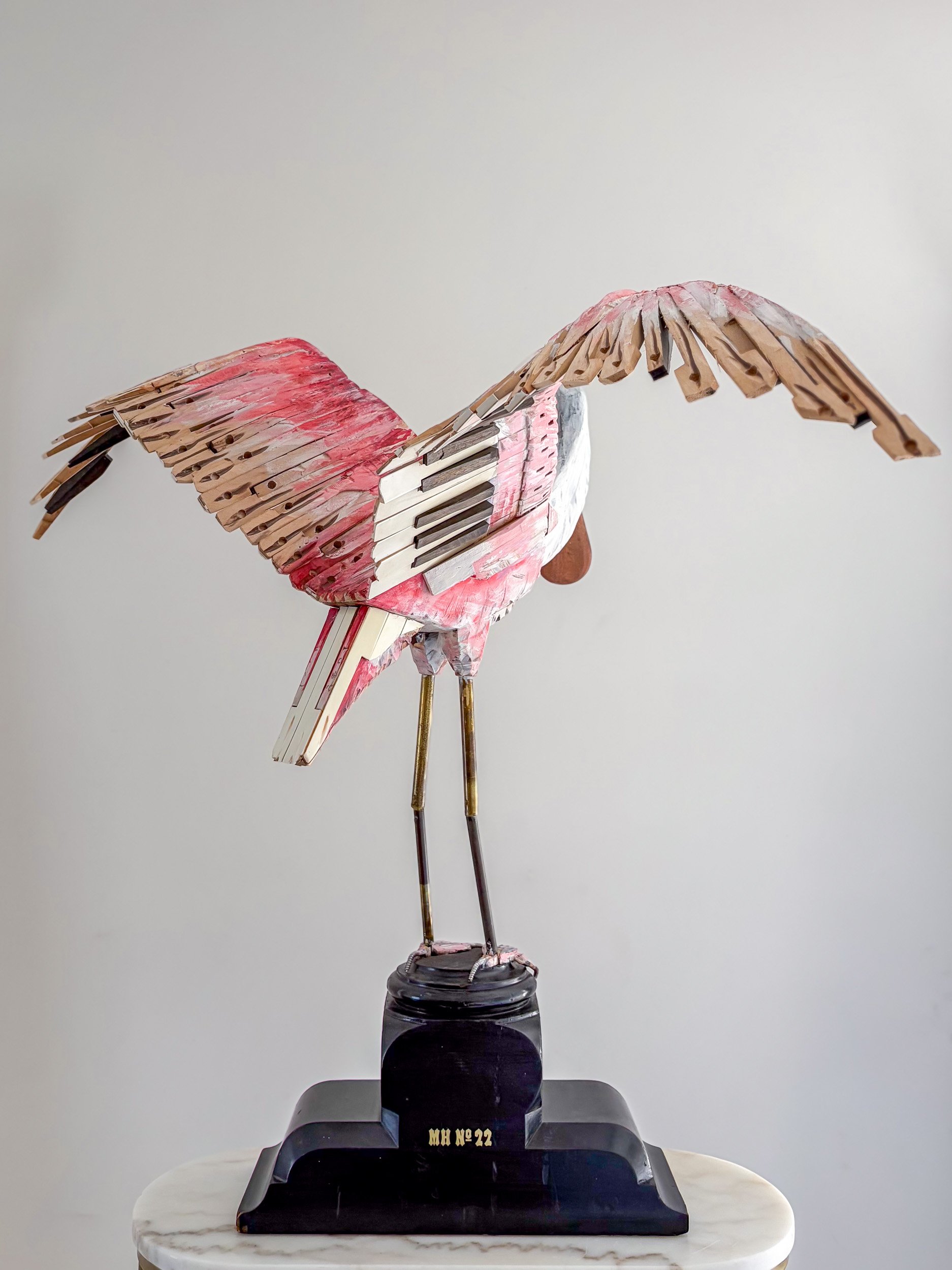Roseate Spoonbill sculpture made from piano parts shown from back view.