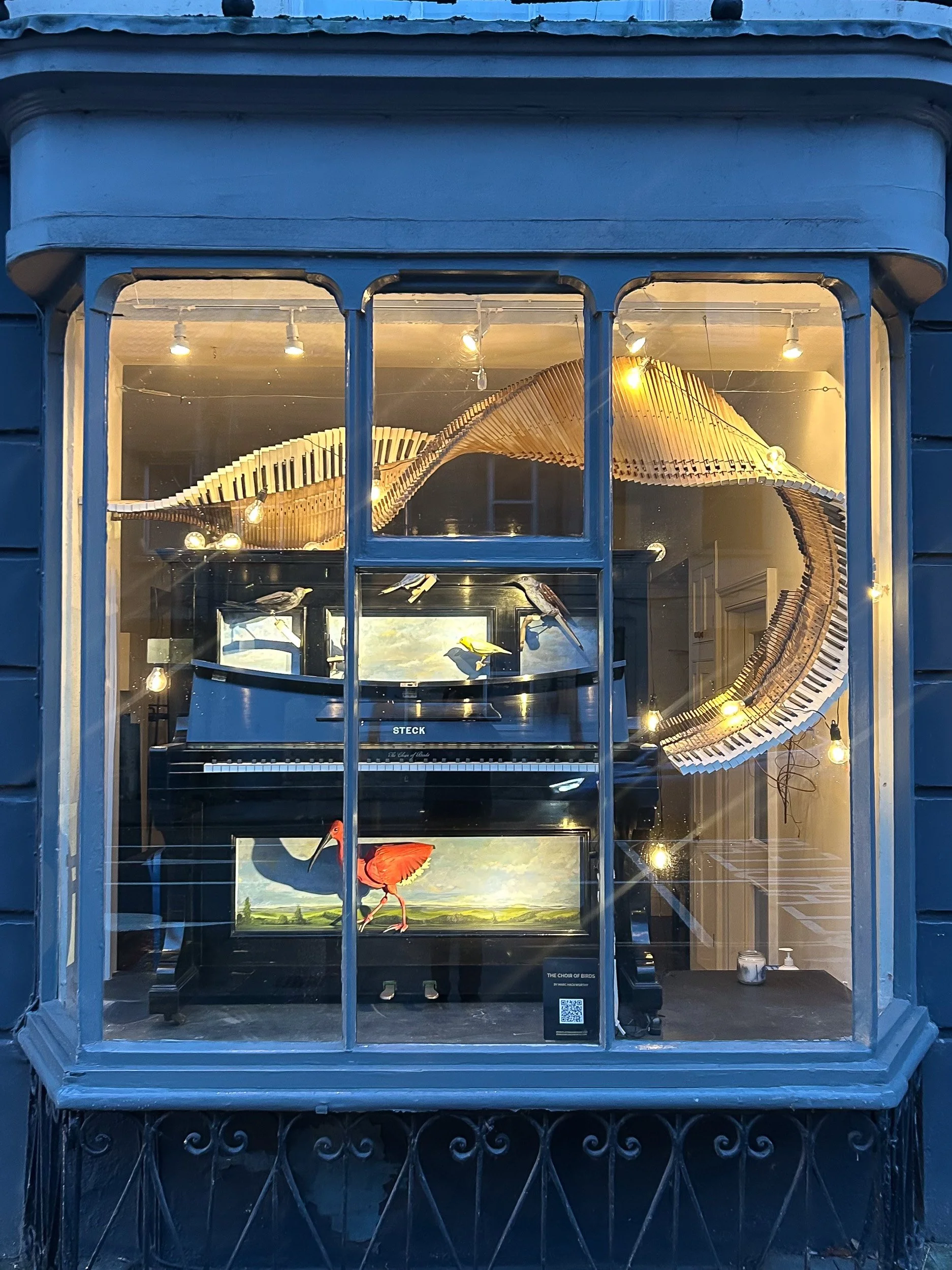 Piano Shop Bath front display windows with Marc's piano sculpture.