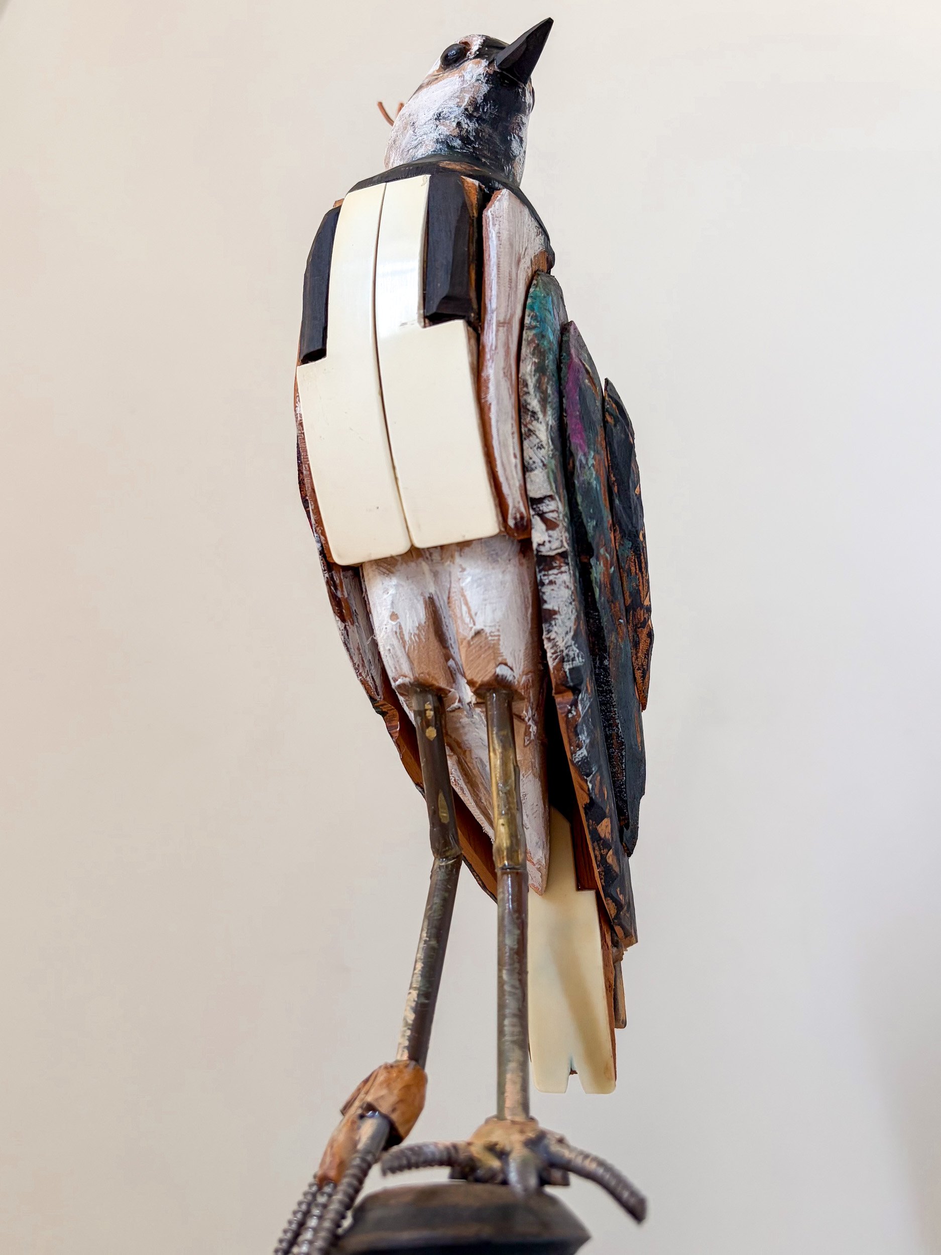 Northern Lapwing sculpture made from piano parts, with close up of piano keys breast detail.