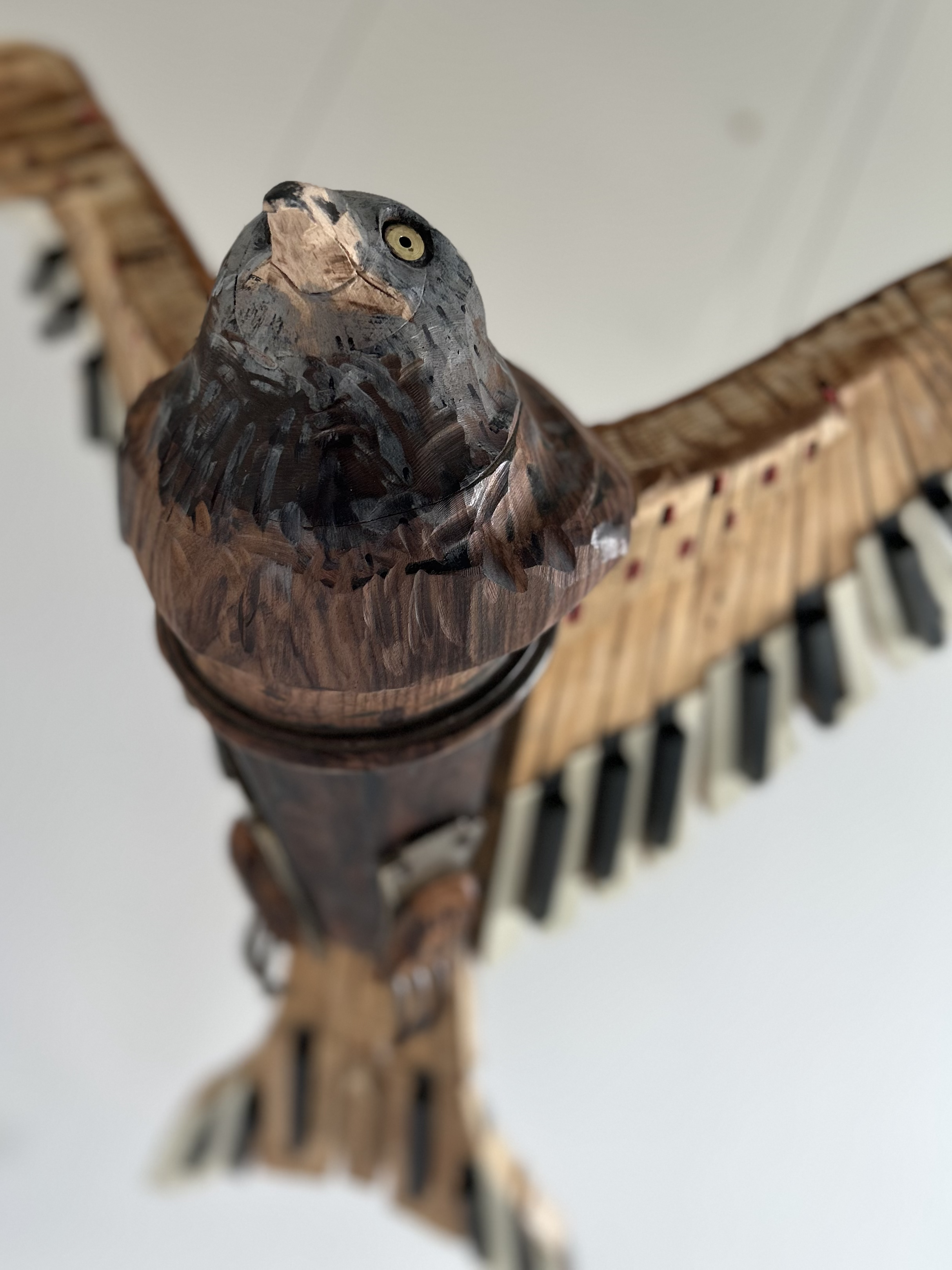 Close up of face of Red Kite sculpture from piano parts.