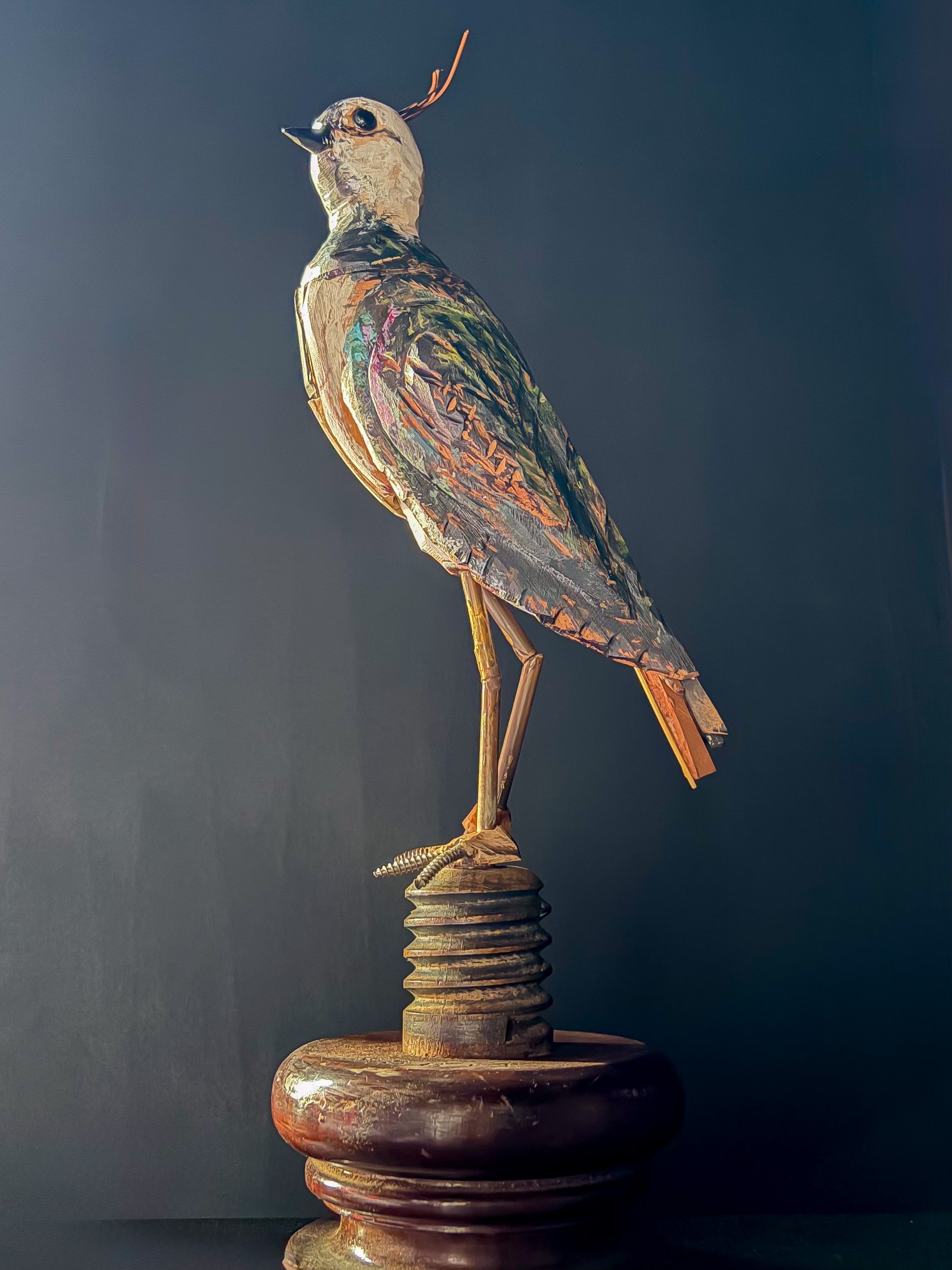 Northern Lapwing sculpture made from piano parts, side profile.