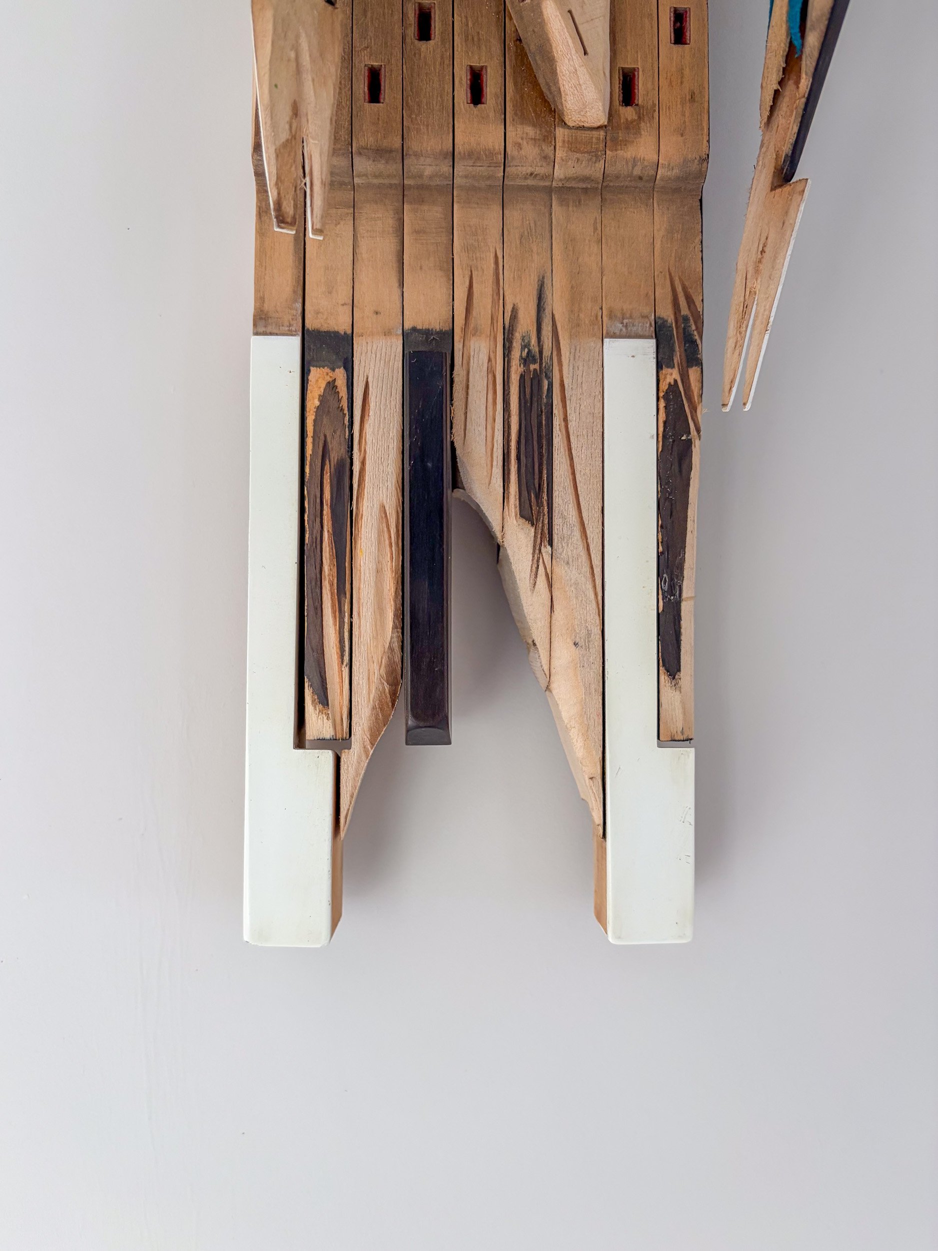 Sculpture of Three Parakeets in F Minor made of piano parts with close up of chord detail.