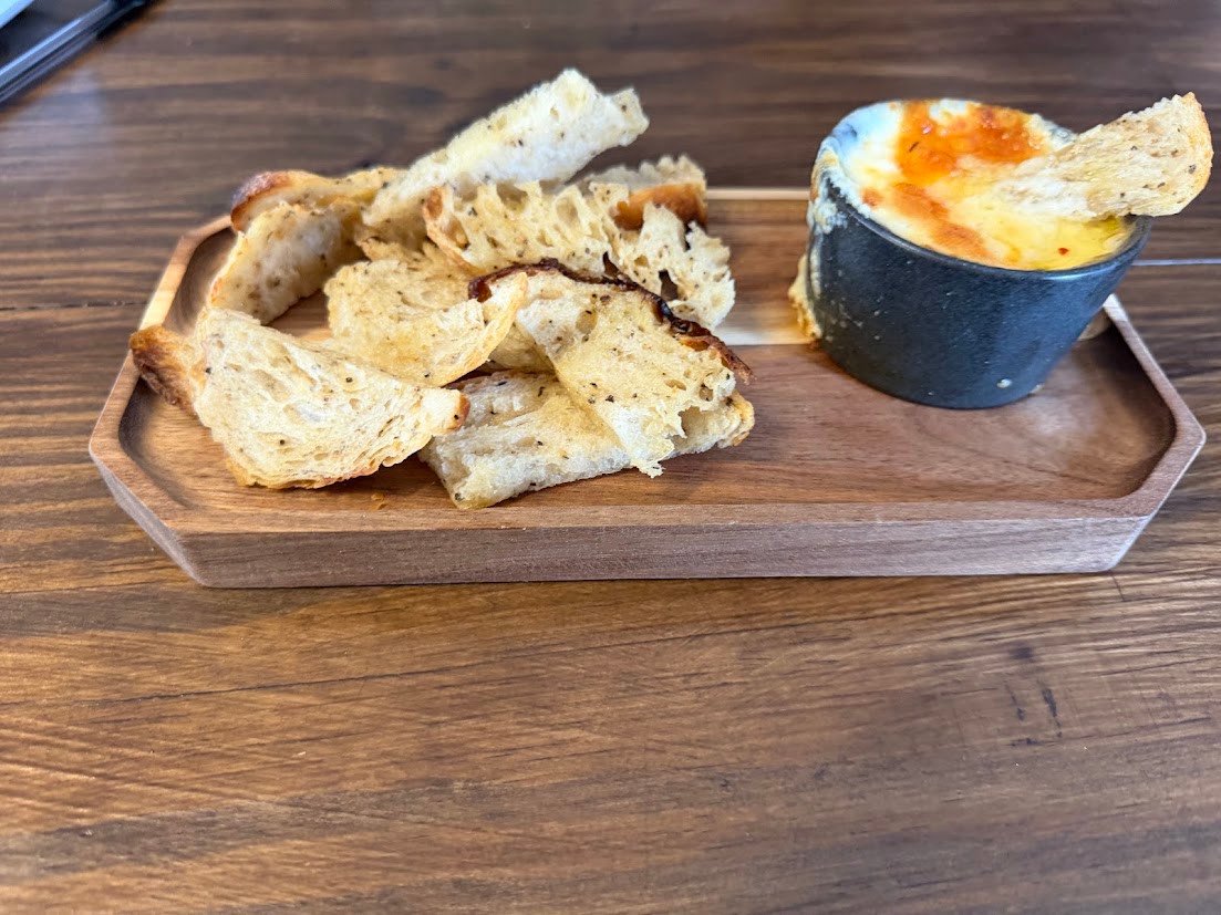 Vinland The GOAT appetizer with baked cheese and sourdough bread