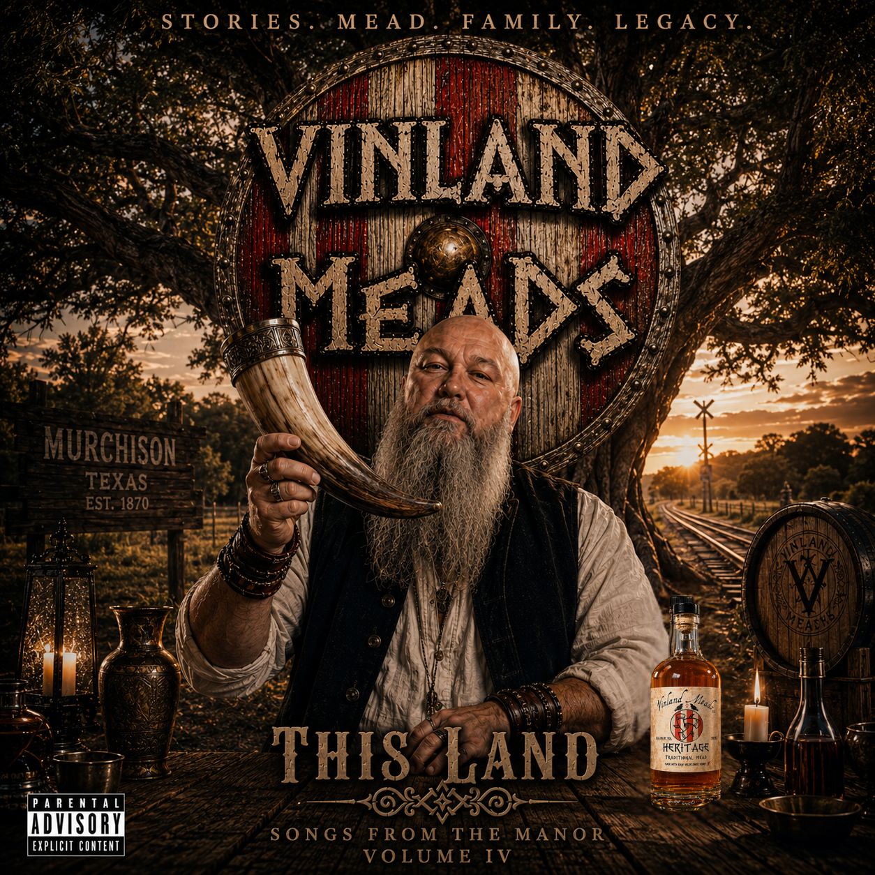 Album cover for 'This Land: Songs from the Manor Volume IV' by Vinland Mead. Features an older man with a long gray beard holding a horn, sitting at a rustic table with candles, bottles, and vases. The background shows a tree, train tracks, and a sunset sky. The text says 'Stories. Mead. Family. Legacy.' and 'Vinland Meadow'.