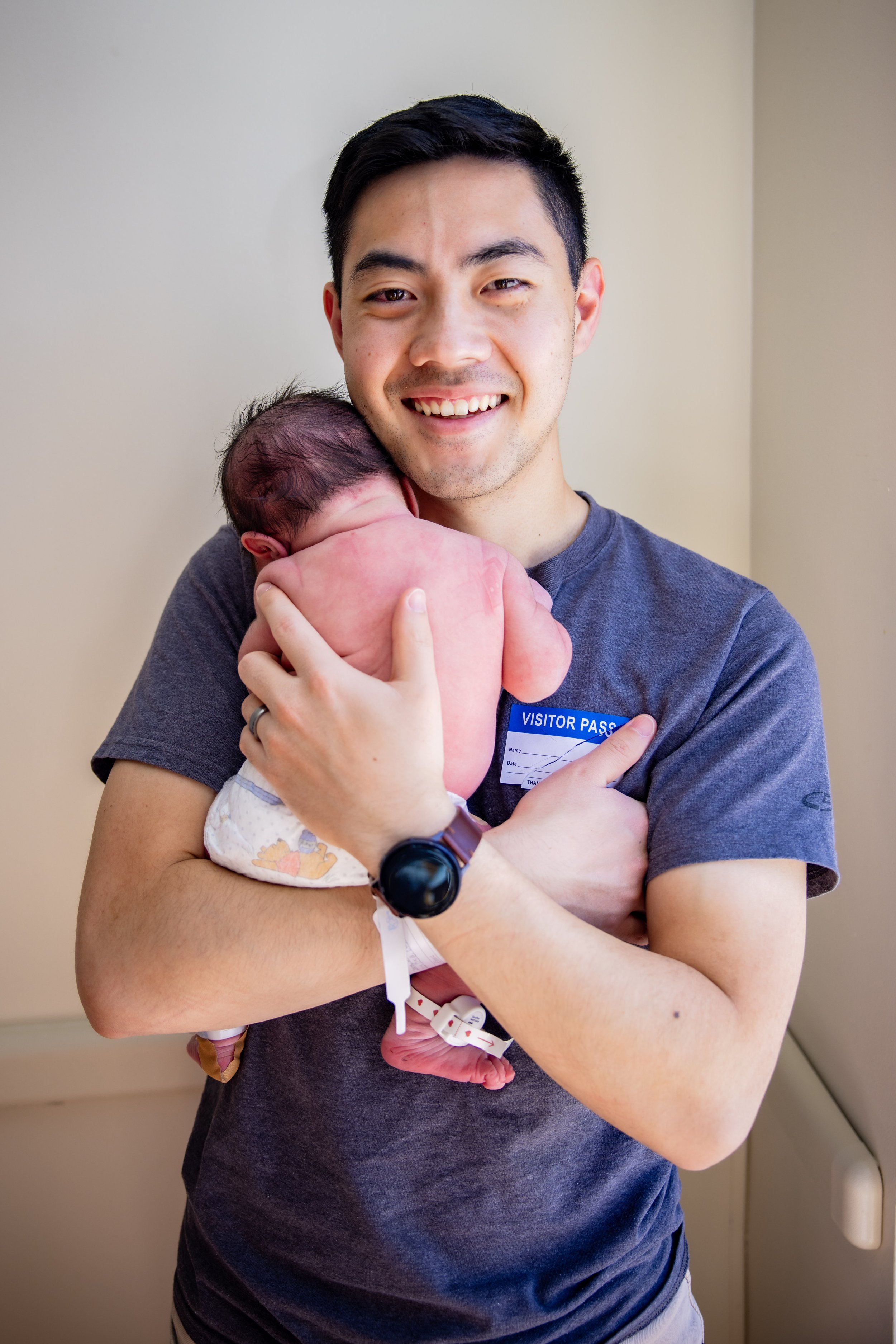 Dad holding newborn baby at a fresh 48 photography session at Doctor's Hospital of Augusta, GA.