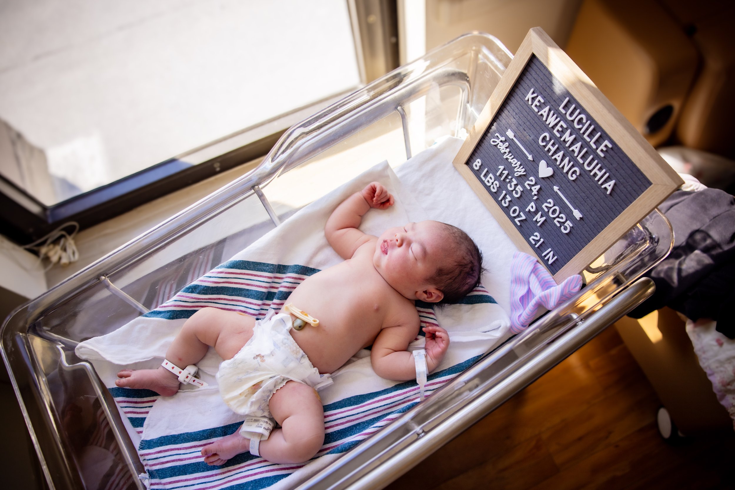 Newborn baby in bassinet with letterboard at a fresh 48 photography session at Doctor's Hospital of Augusta, GA.