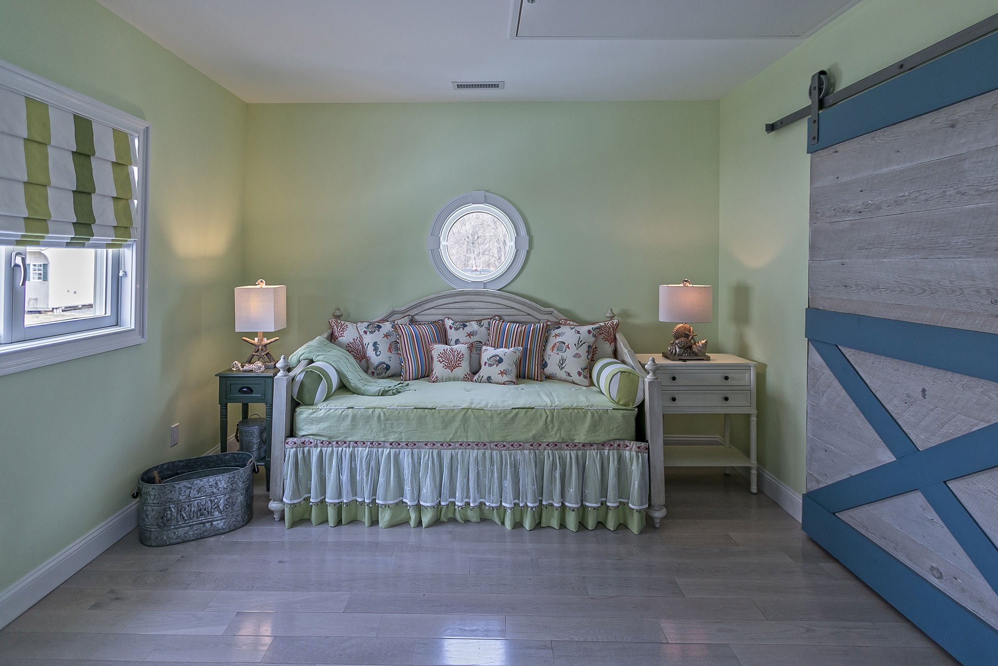 Guest Room (Trundle & Desk)
 The guest room is designed for flexibility — a space that adapts as easily as the tide. A trundle bed tucks away beneath the daybed, keeping the room open when not in use, while a small writing desk turns a quiet corner i