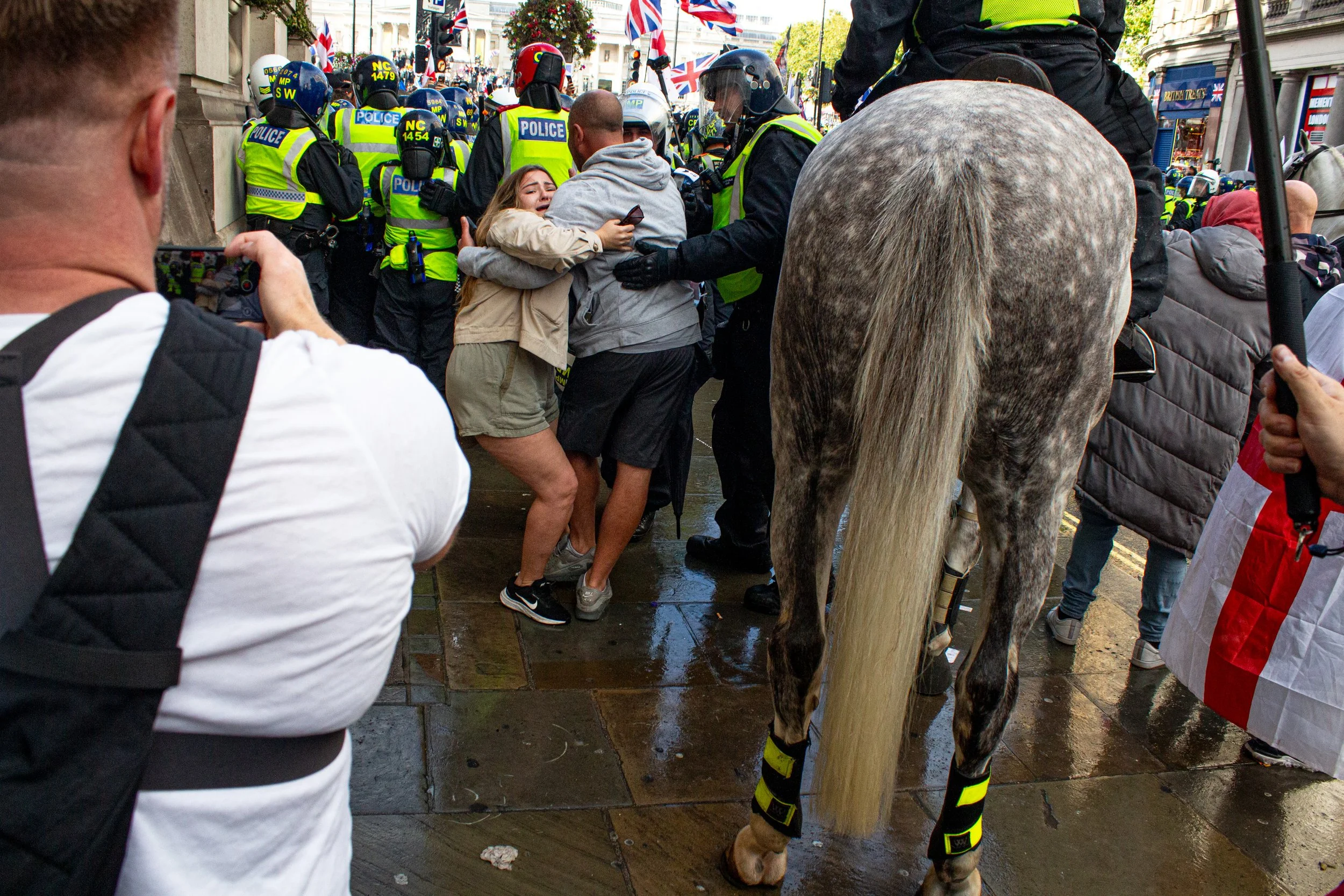 Police try and move aside two members of the far-right.