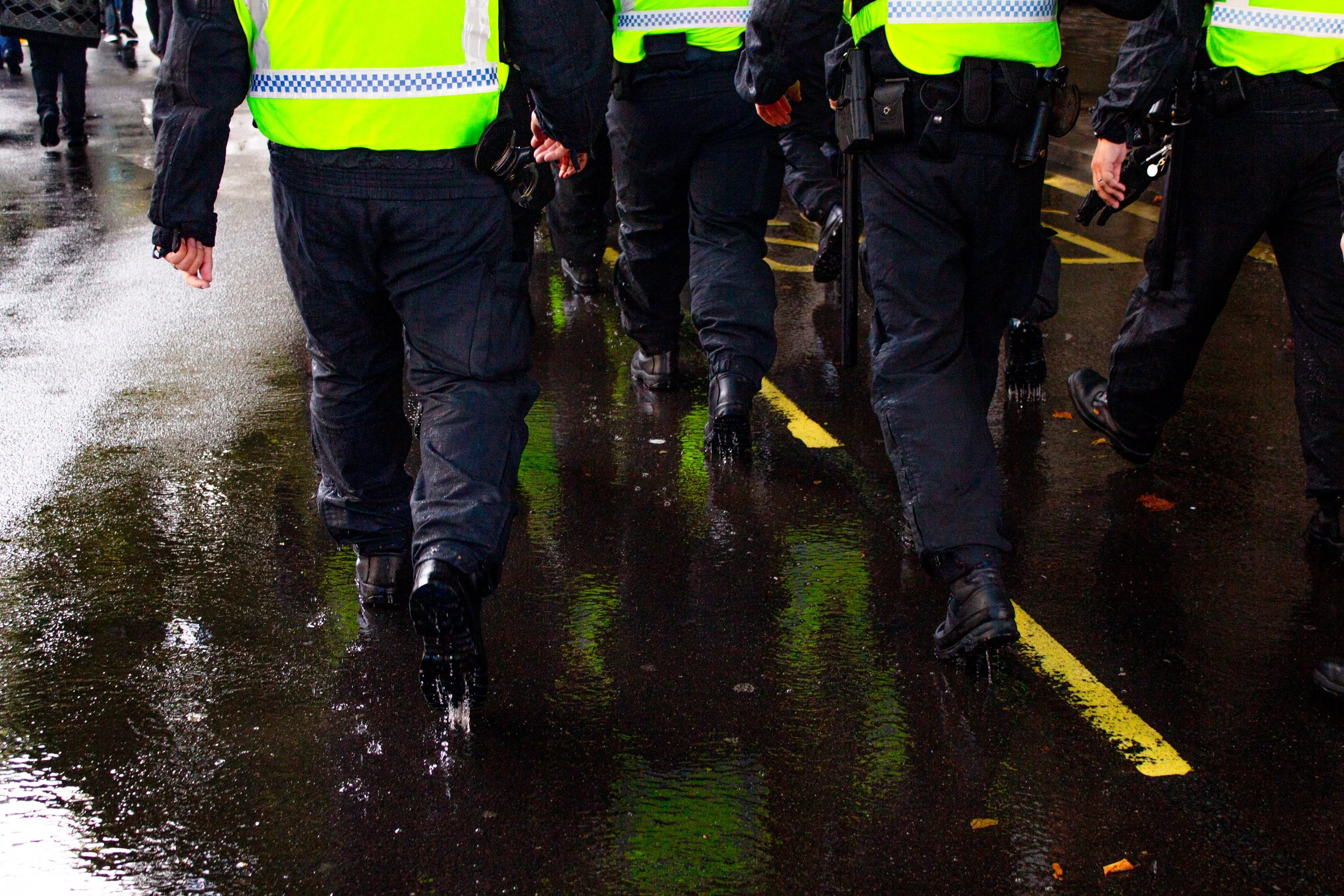 A group of police march alongside the counter protest.