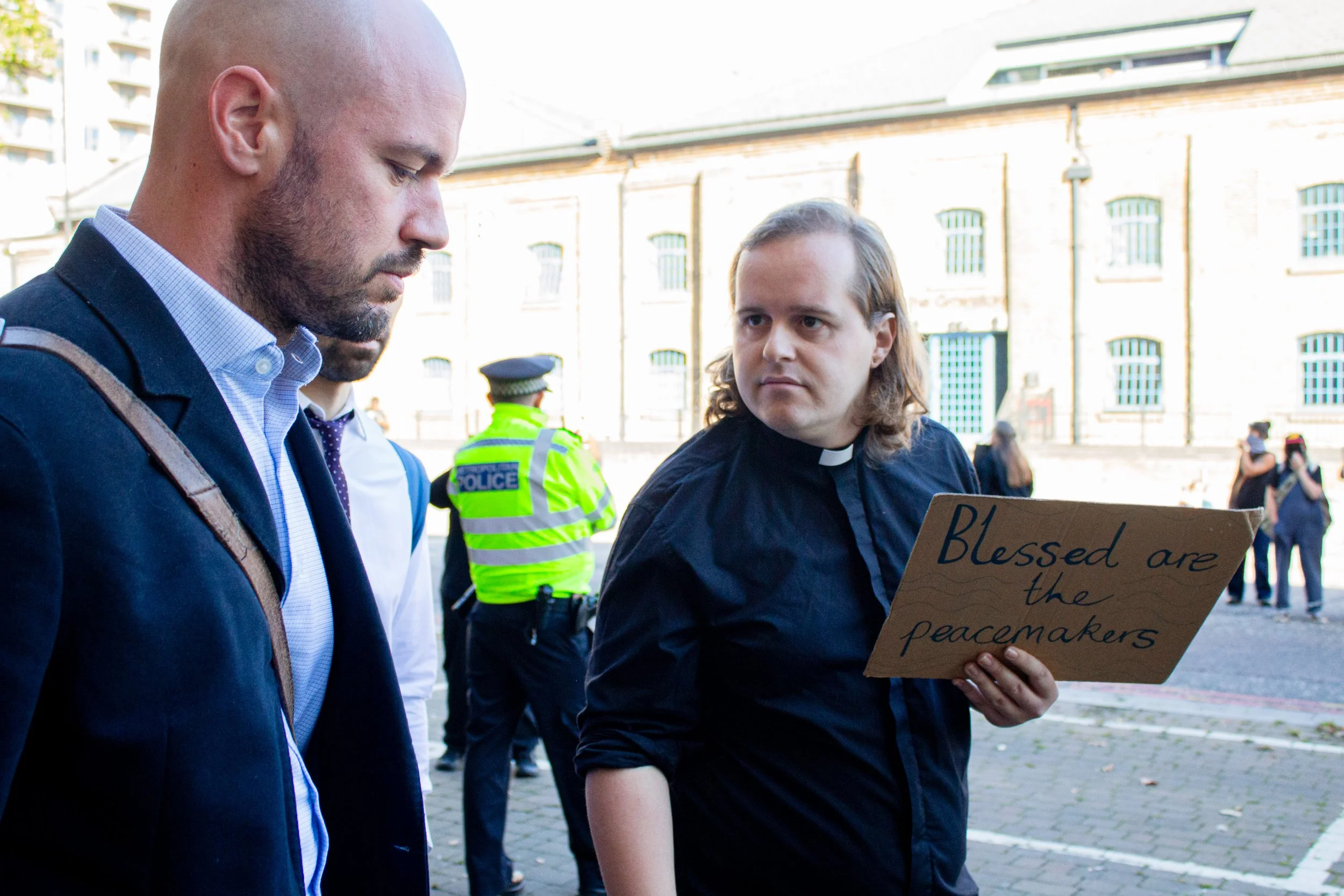 Sam, a priest from the Church of England in Exeter, confronts attendees of the DSEI Arms fair, 2025.
