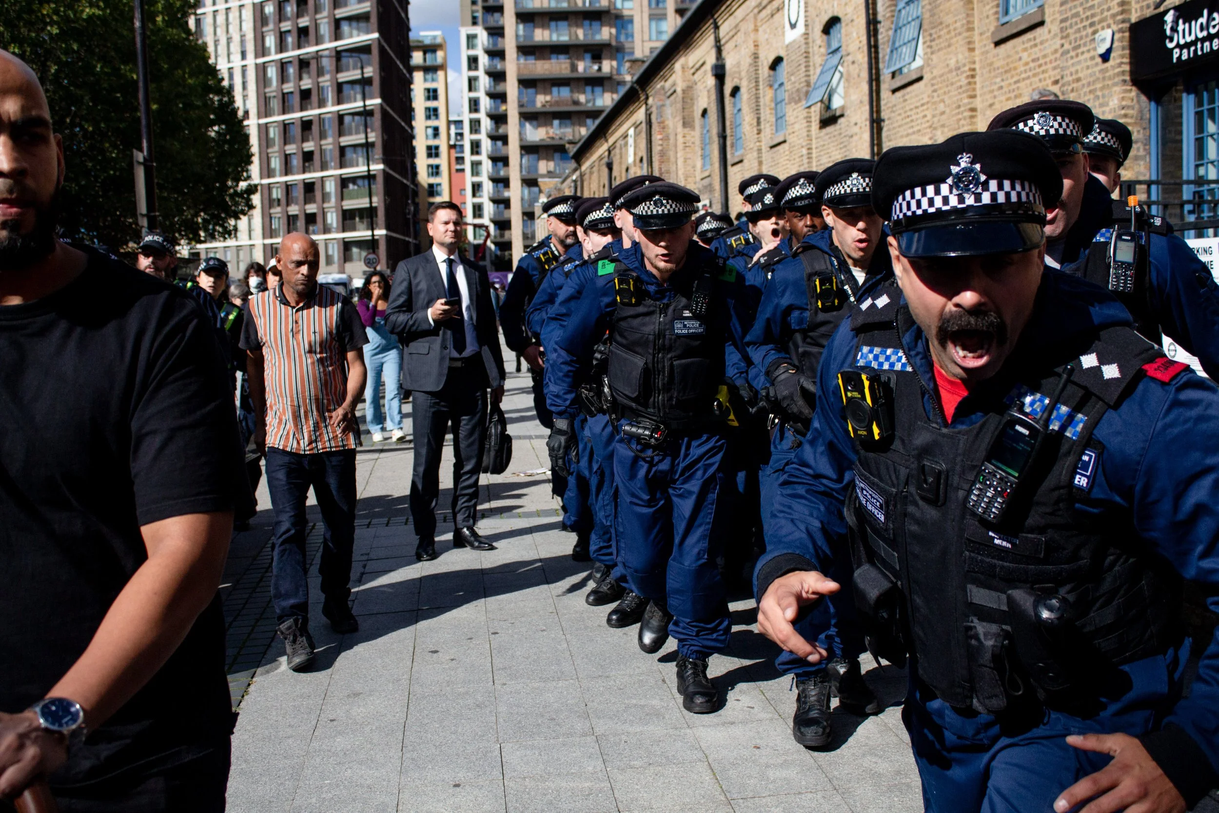 Police in formation charge towards the anti-arms protest at Excel London, 2025.