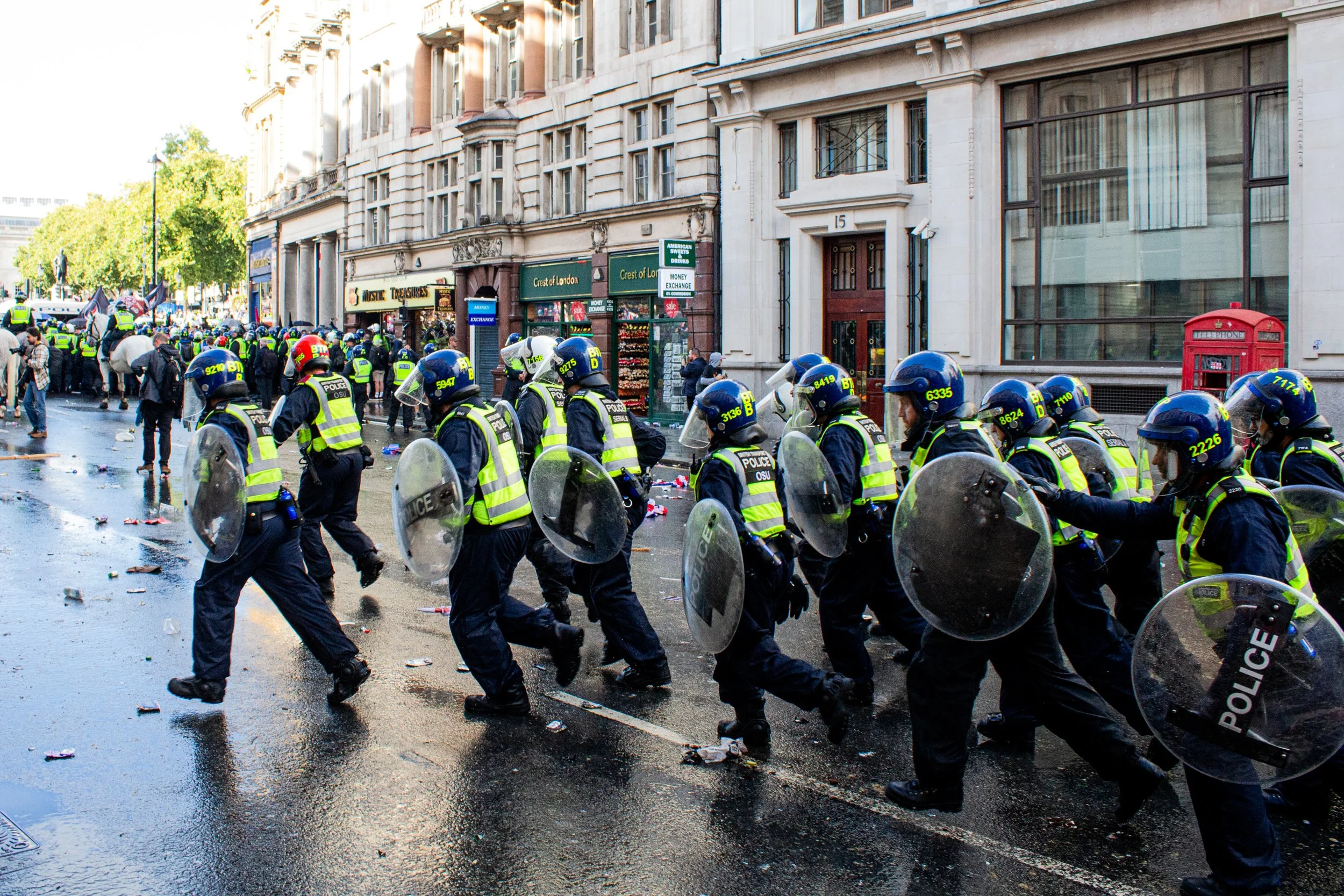 Riot police run towards the far-right crowd.