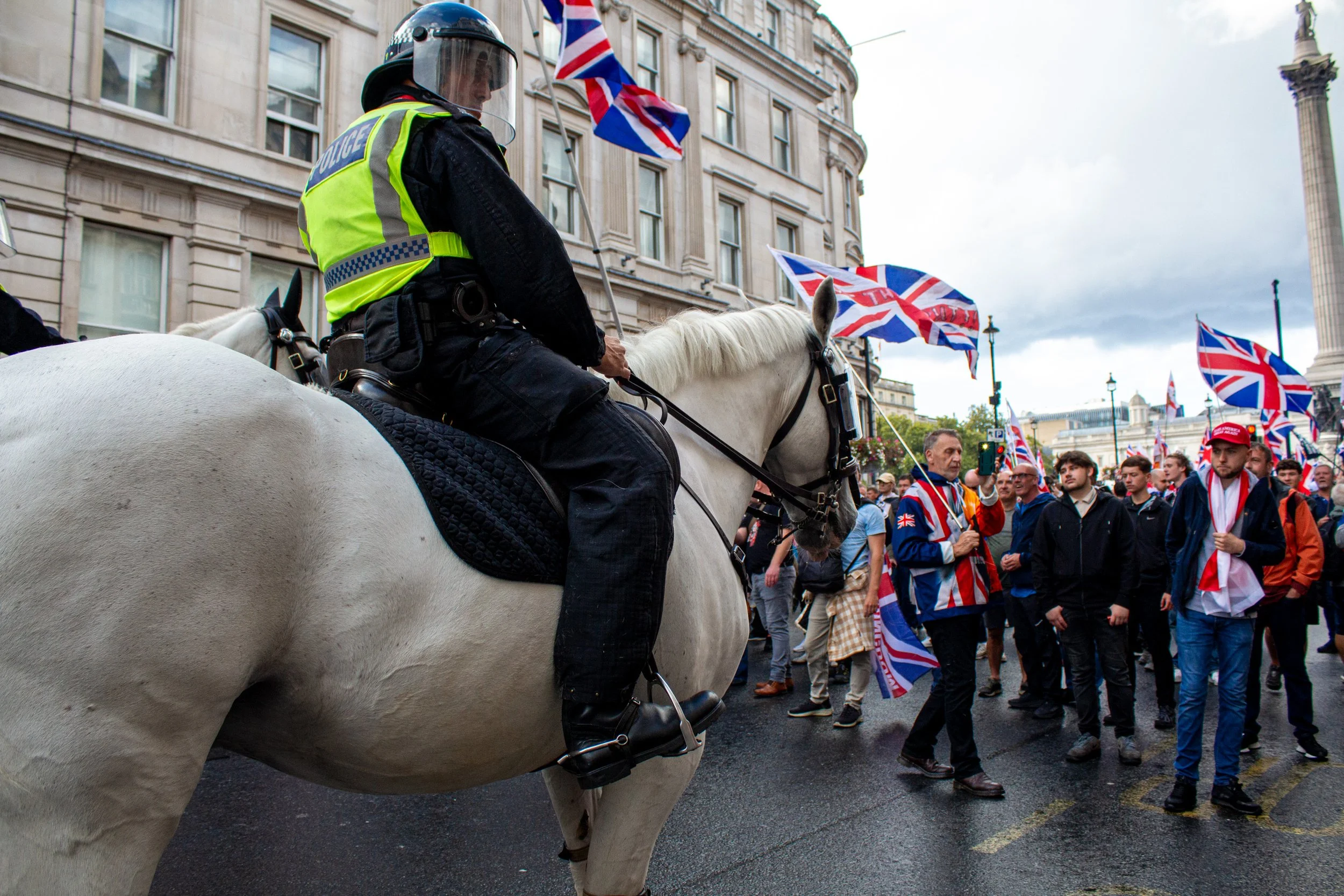 Police horses attempt to break up the crowds.
