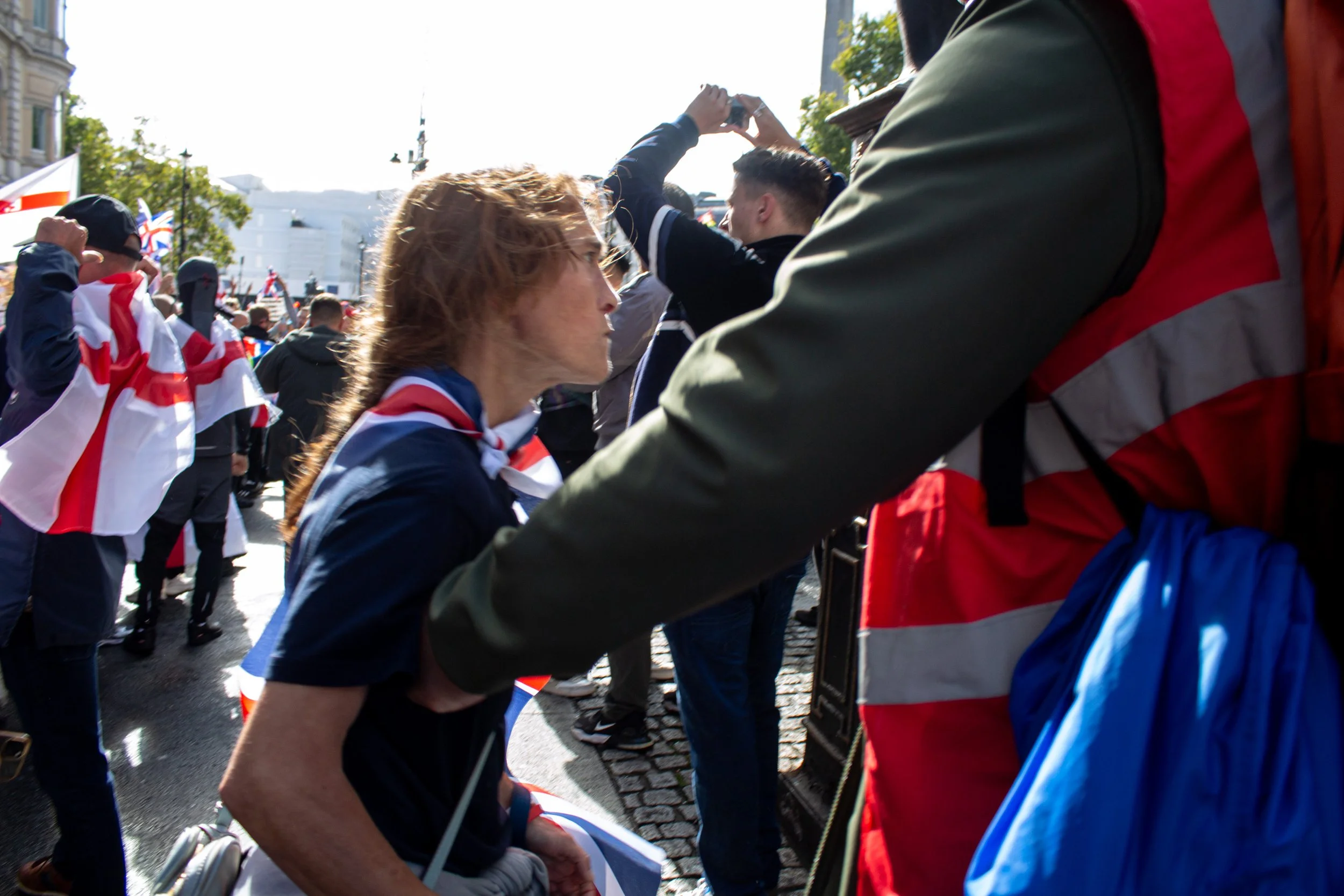 A far-right protestor is held back as she advances towards a member from the counter protest.