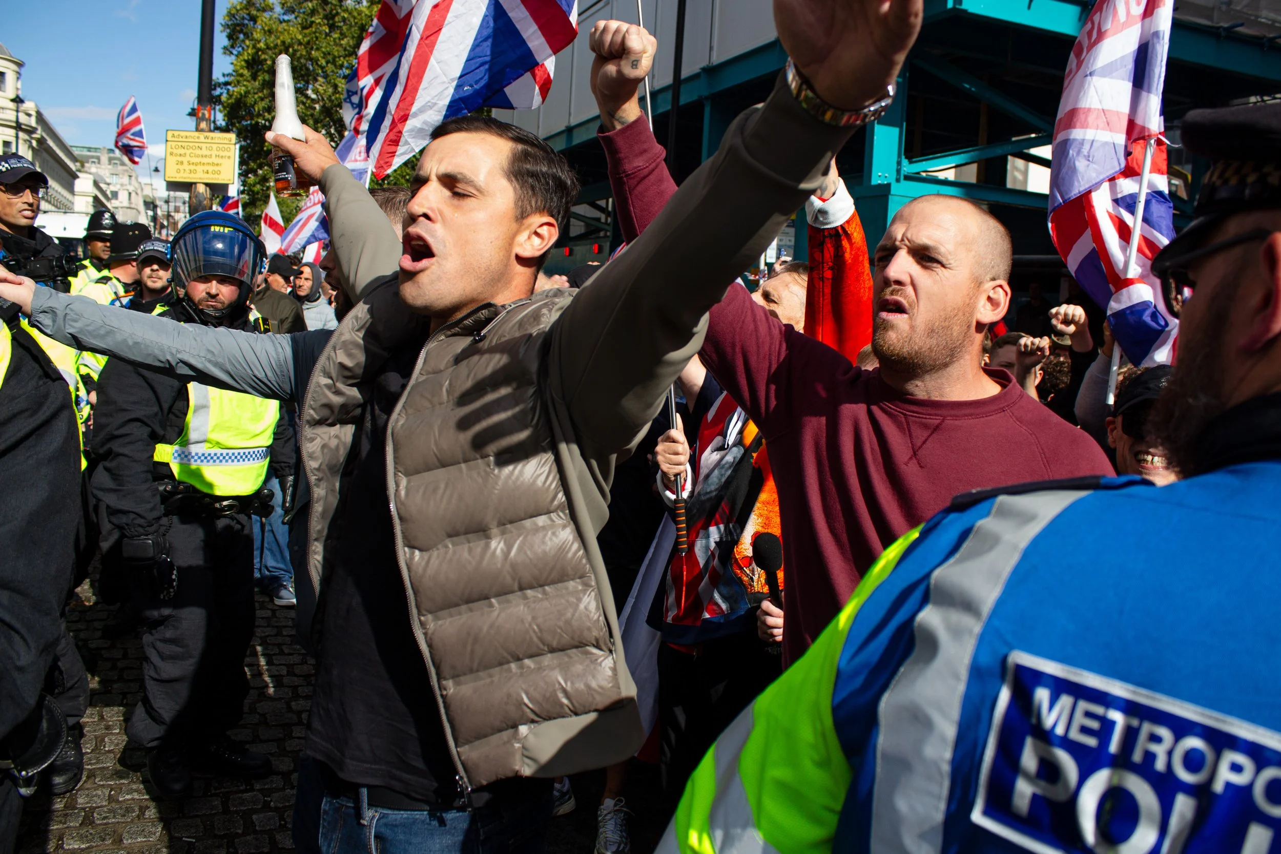 Men with beer bottles bypass the essentially innefective police-lines.