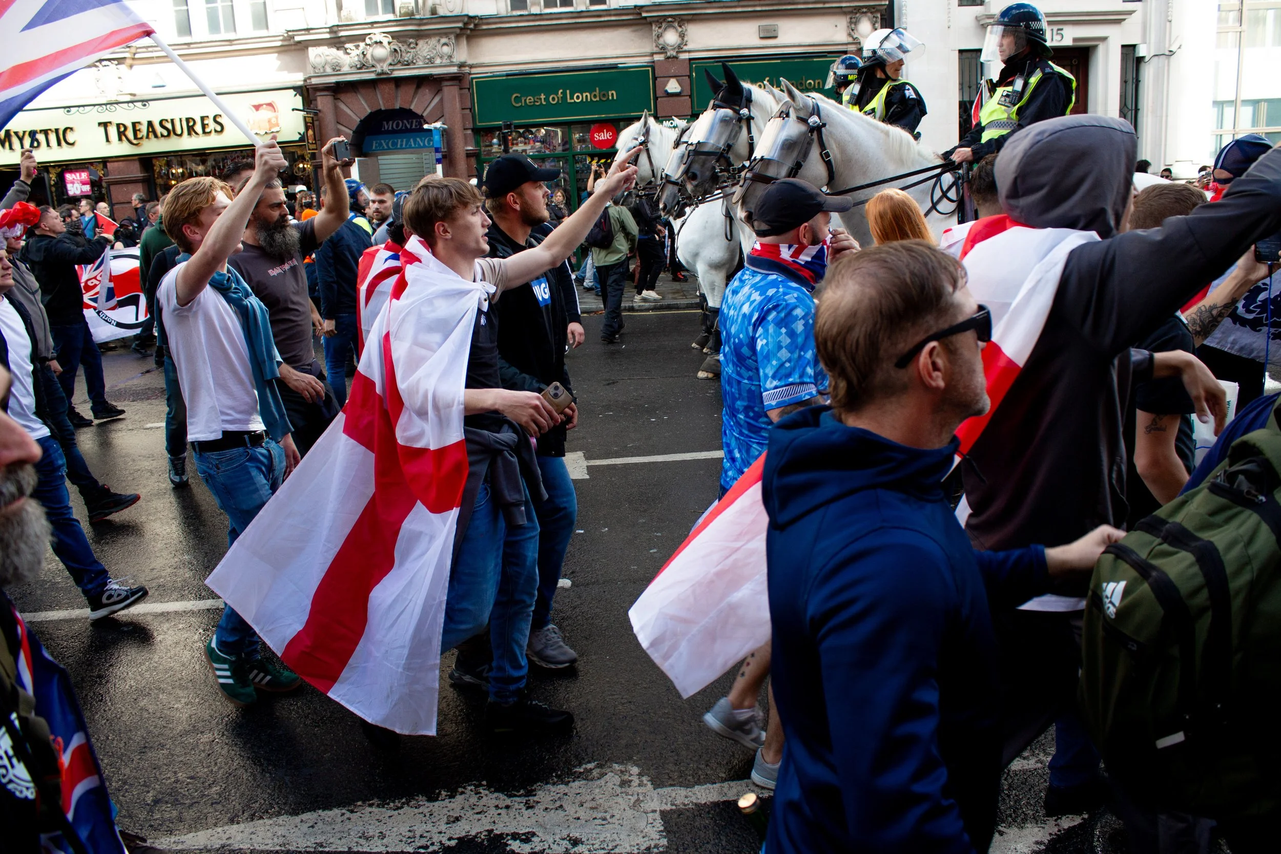 Far-right protestors advance towards the counter protest, despite the police horses between the two groups.