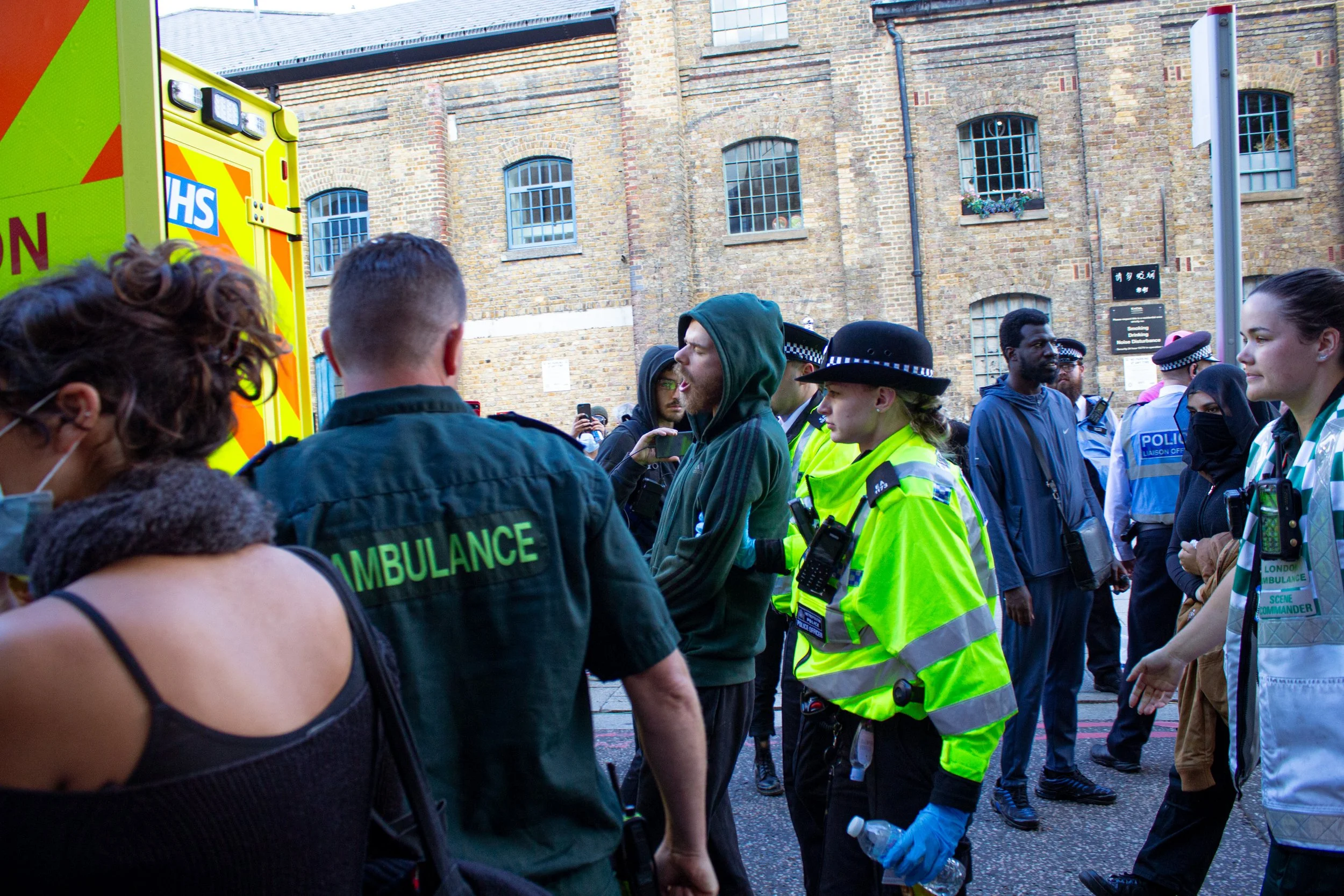 A protestor shouts 'Free Palestine' while being escorted to an ambulance by police at the DSEI Arms fair, 2025.