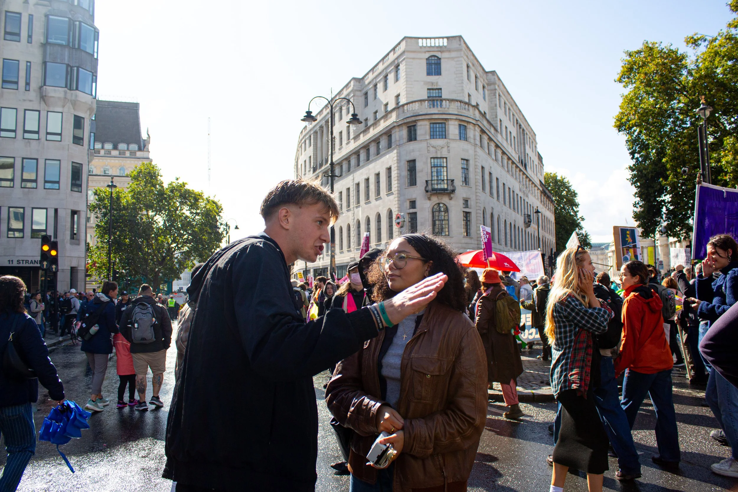 A counter protestor and far-right protestor discuss issues against the backdrop of the marches.