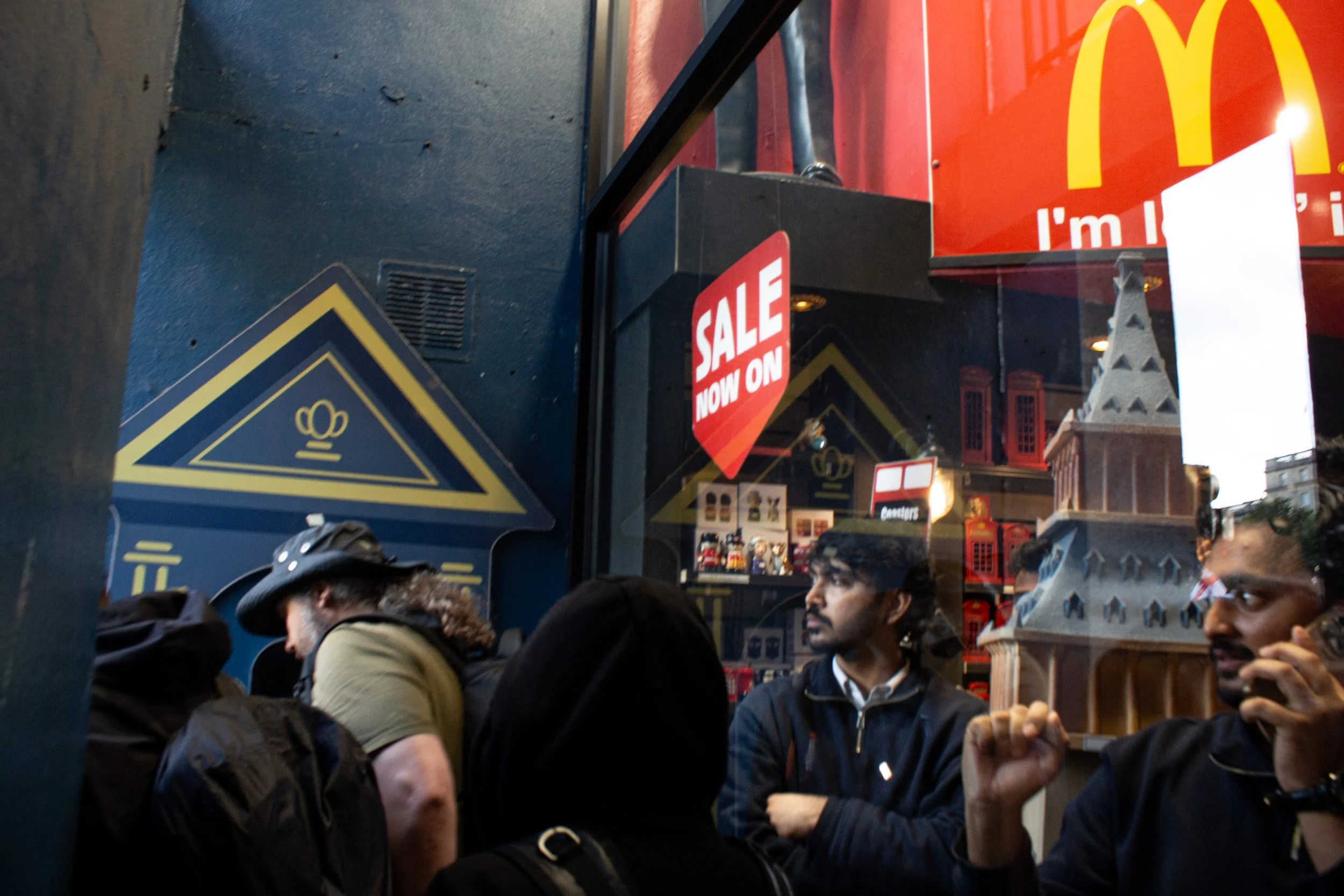 Employees watch the protest from within their shops.
