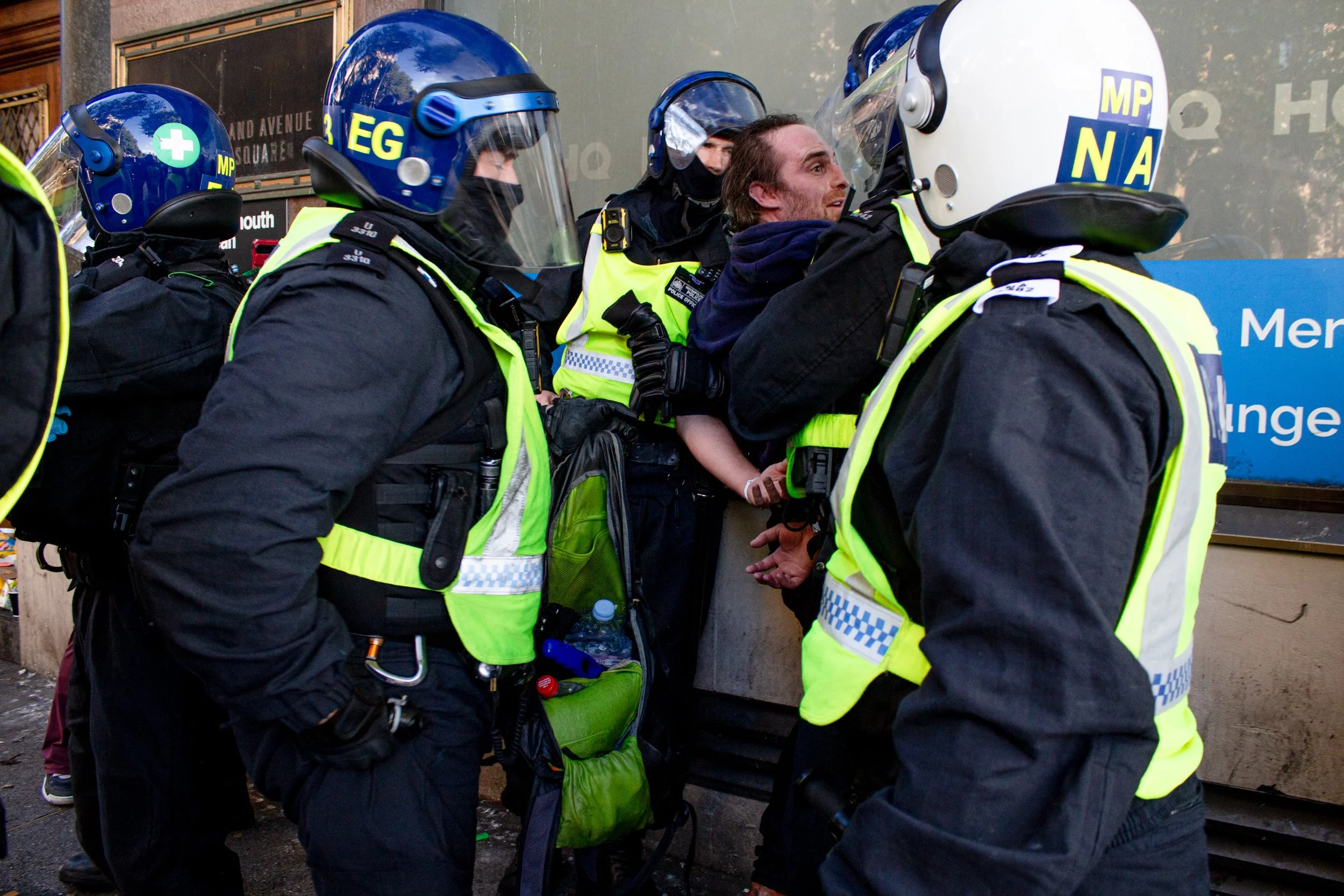 Police empty the contents of a bag belonging to a man from the far-right. Items in the bag include a kitchen lighter and aerosol can.