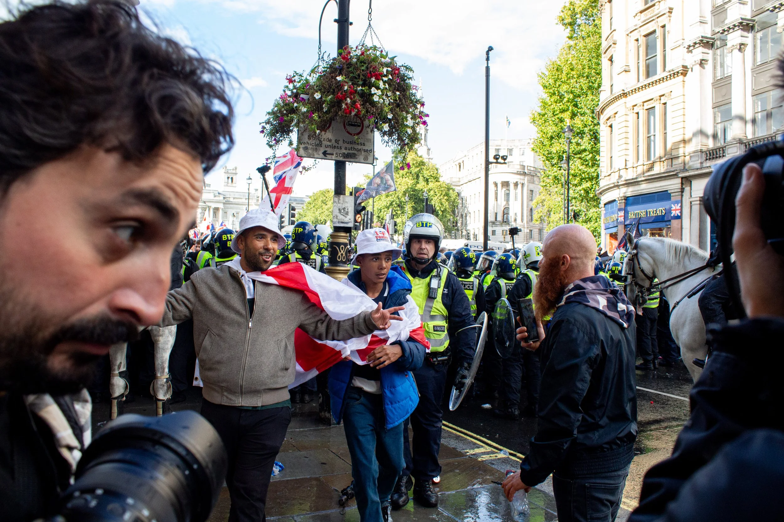 A man and his son emerge from the far-right crowd.