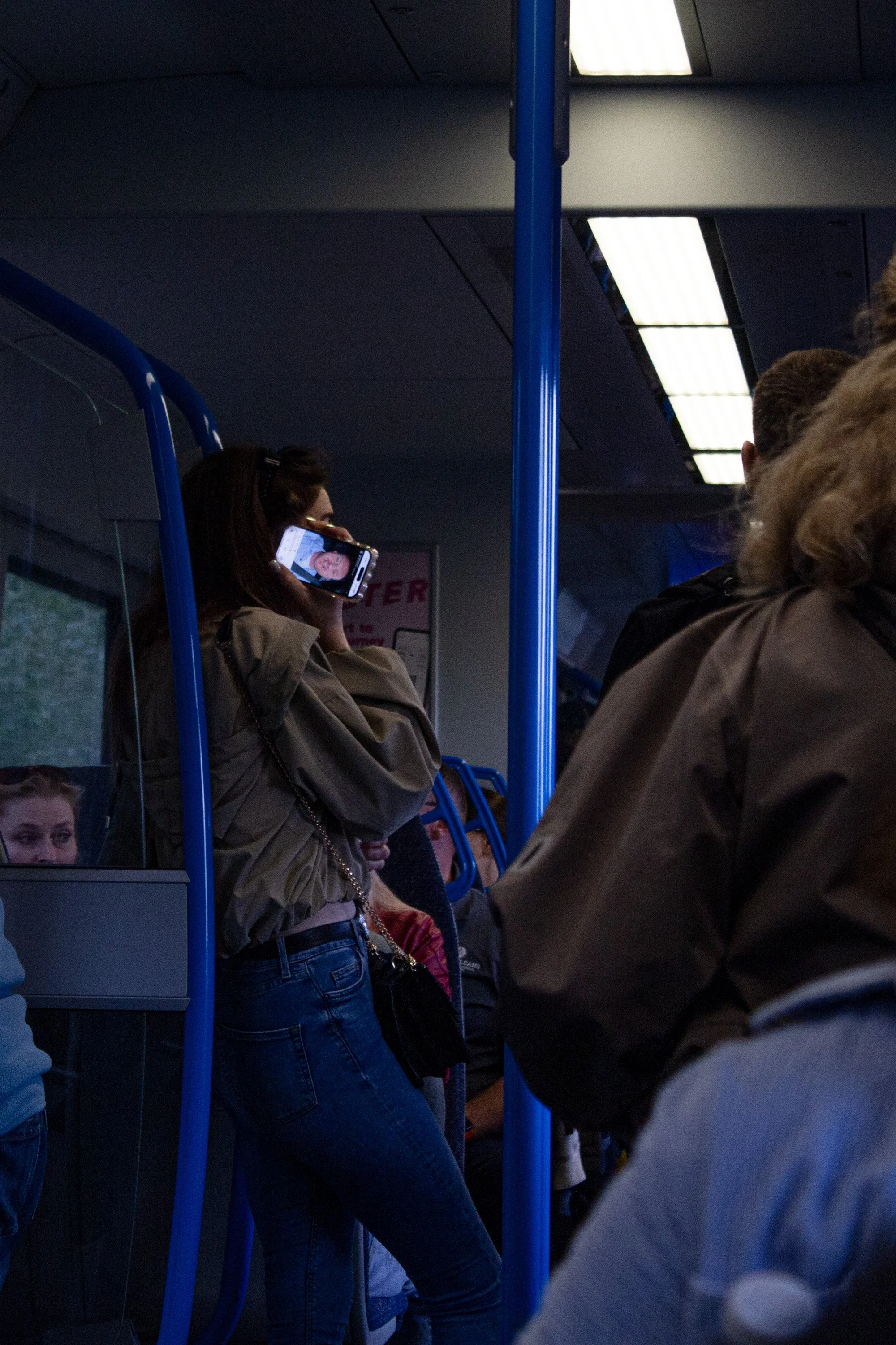 A woman listens to a Tommy Robinson video on the Thameslink train into central London.