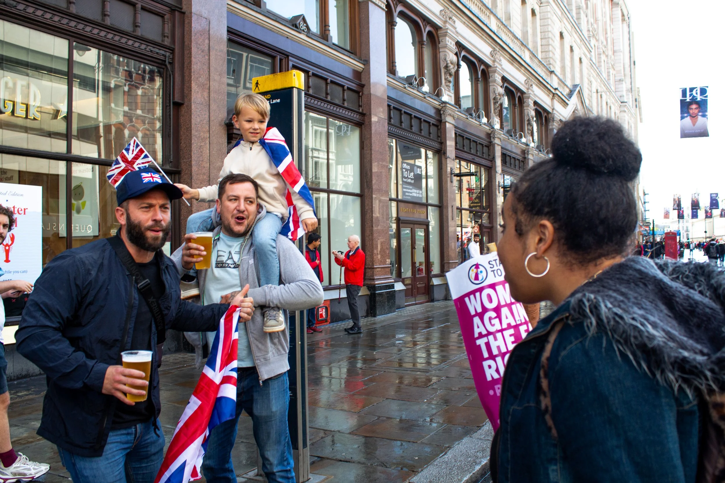 A counter protestor confronts two men.