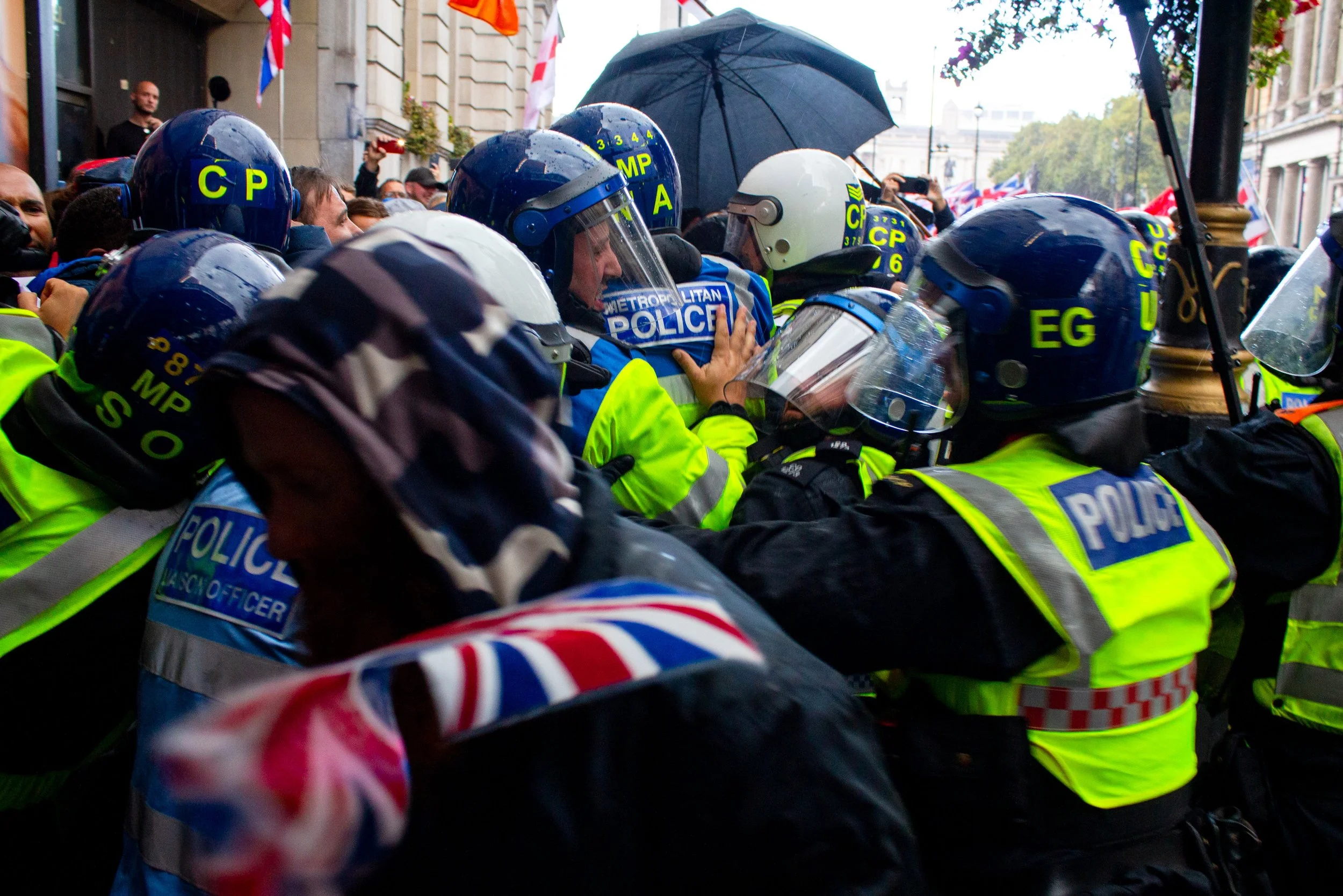Riot police push the far-right further back.
