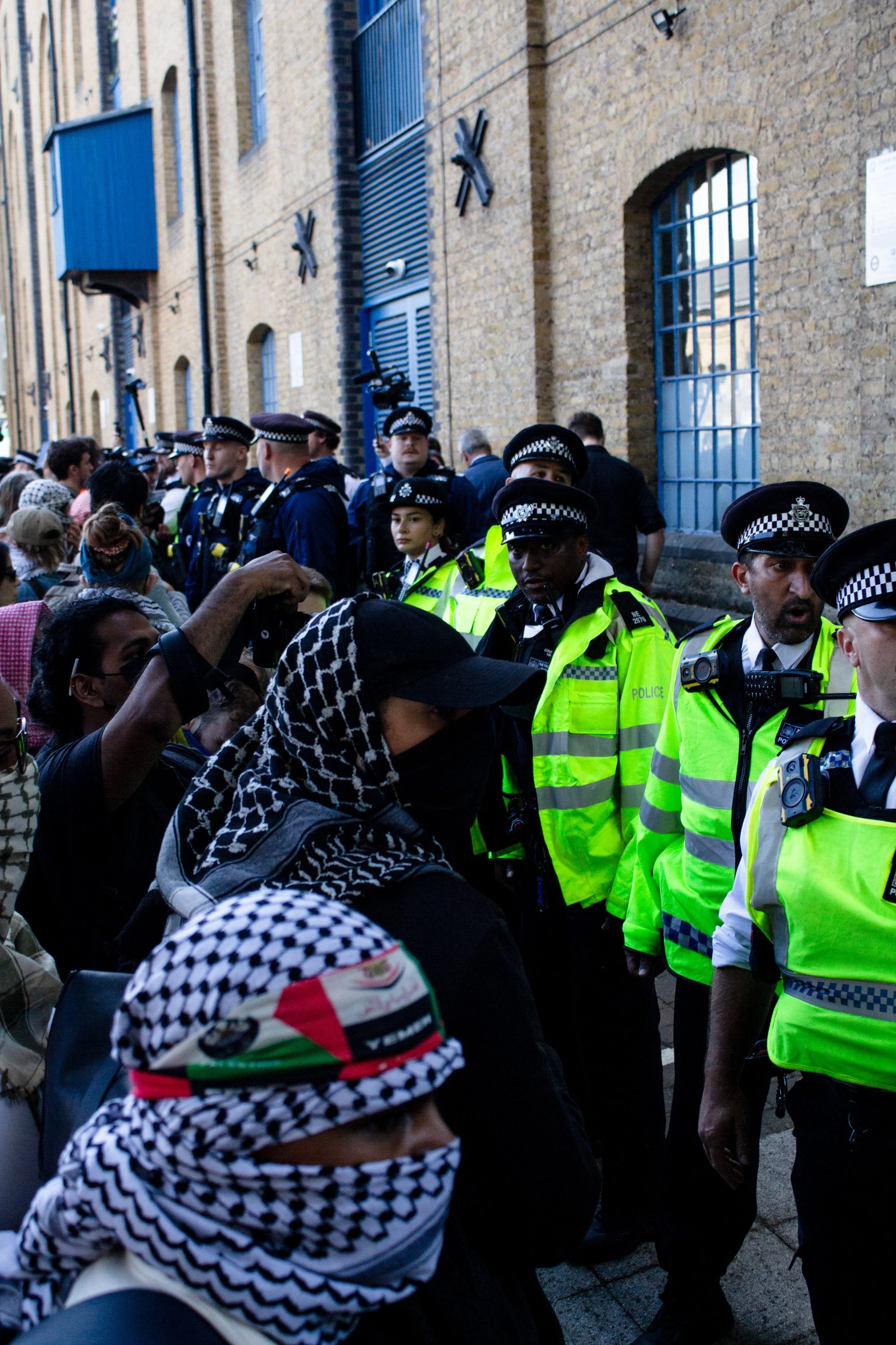 Police form a blockade between protestors and attendees at the DSEI Arms fair, 2025.