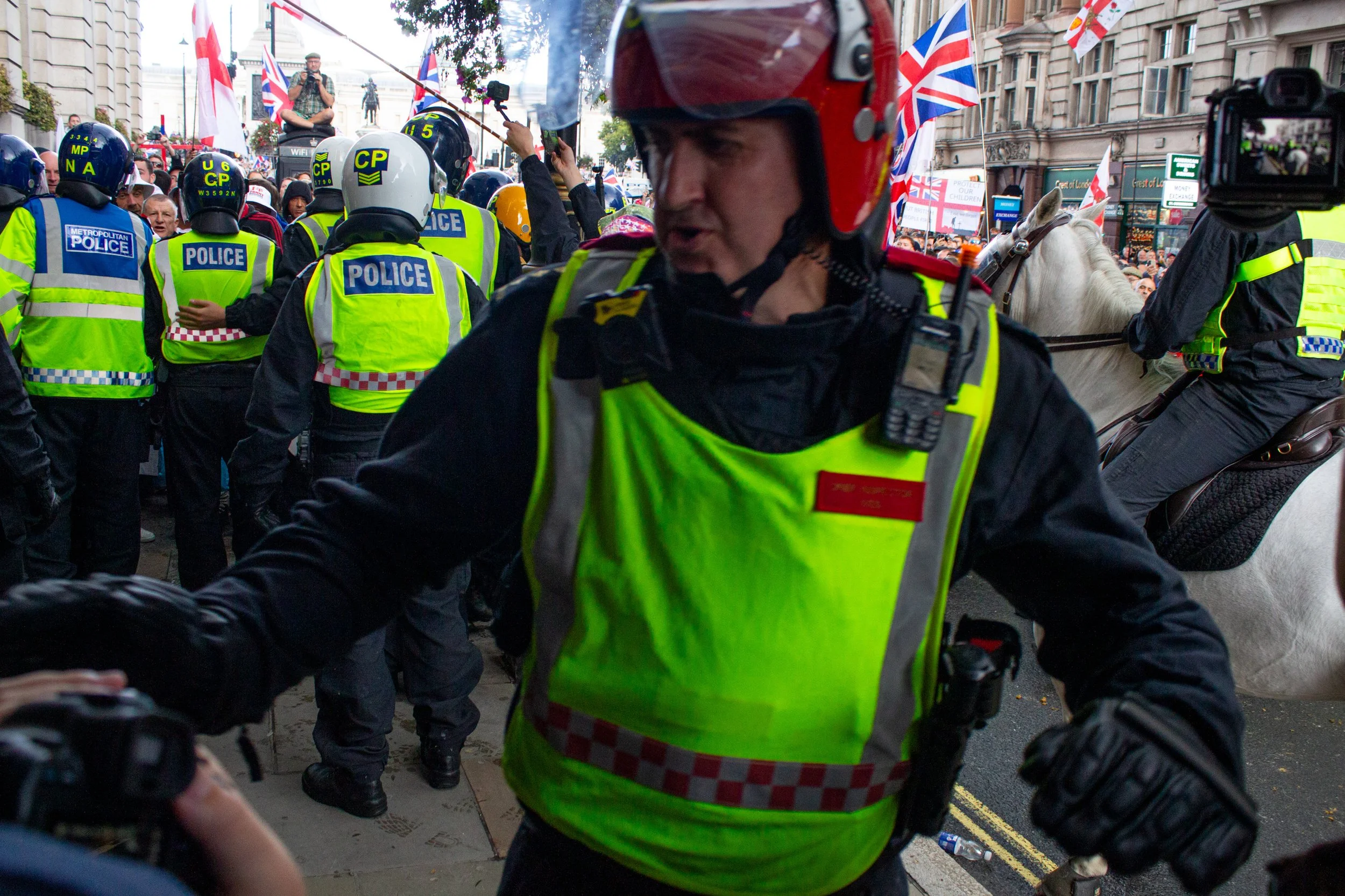 Police push press back while horses and officers in riot gear push the far-right further away towards Trafalgar Square.