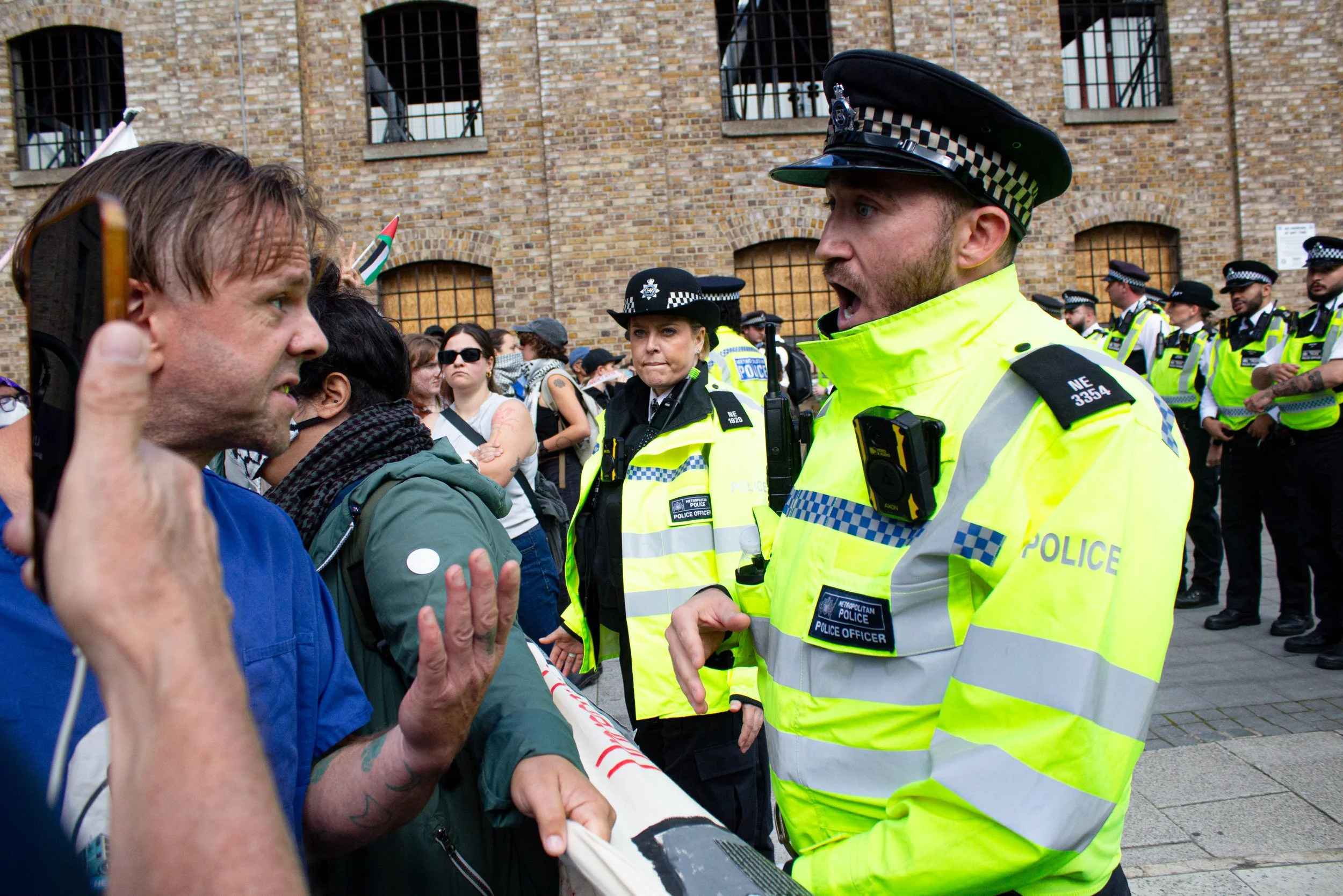 Leigh Evans, a Welsh nurse who worked in Gaza and an activist in the Western pro-Palestinian movement, speaks to police as they pushed the protest away from the DSEI Arms fair, 2025.