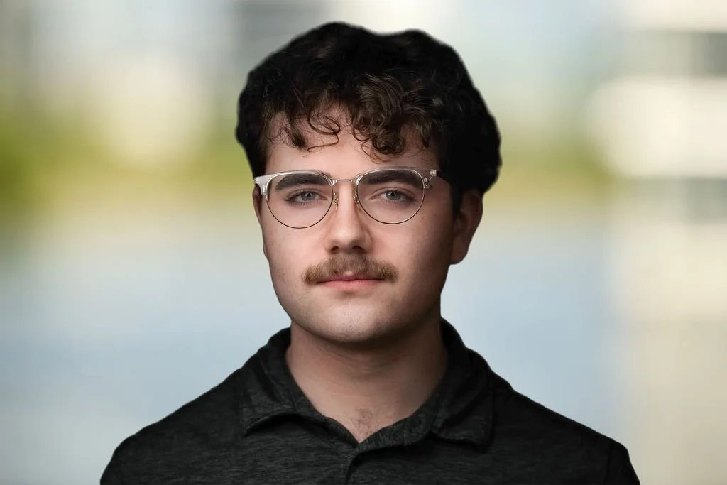 Silhouette of a person with text that says 'Photo Coming Soon' in front of a gray background.