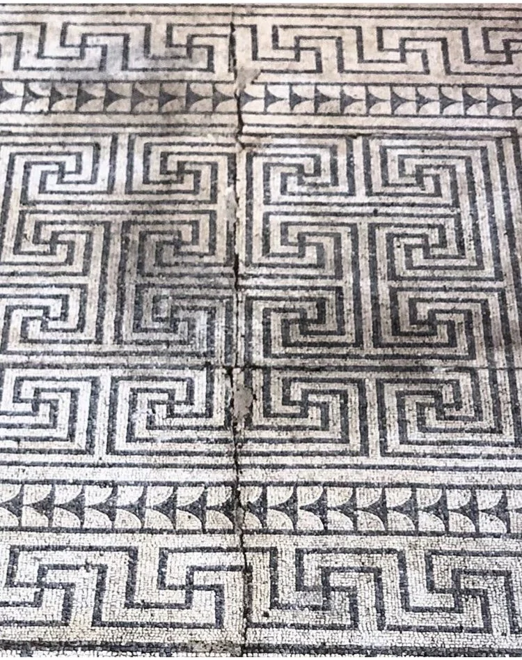 Ancient stone floor tiles with Greek key and meander patterns