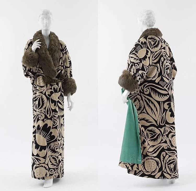 Mannequin dressed in a long dress with bold floral print, brown faux fur shawl, and matching cuffs, against a plain white background.