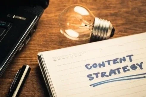 Notebook labeled Content Strategy representing intentional marketing and the consideration stage.