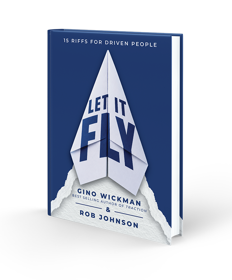 Book cover titled 'Let It Fly: 15 Riffs for Driven People' by Gino Wickman and Rob Johnson, featuring an origami paper airplane creating the words 'LET IT FLY' on a blue background.