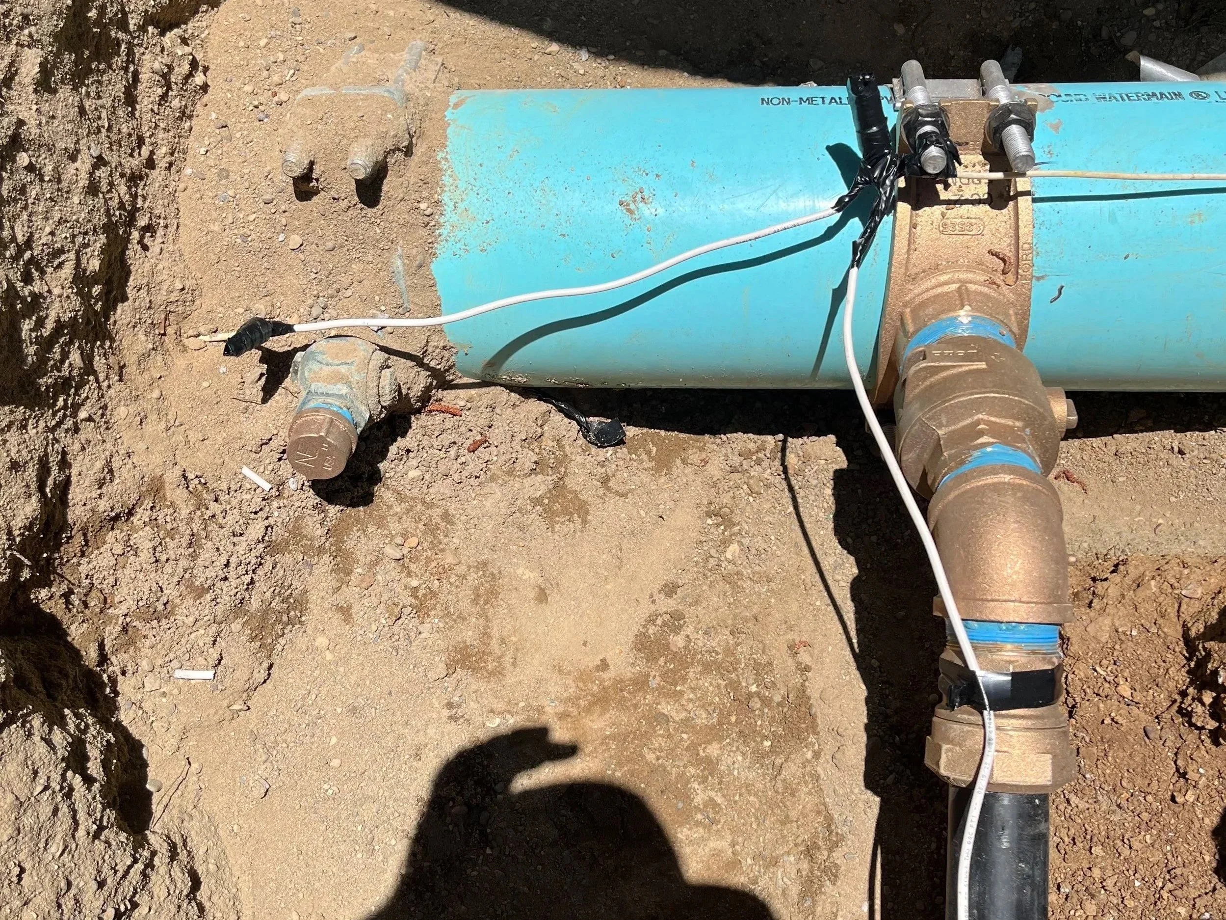 A new two-inch water service, installed by hot tapping through a brass tapping saddle and a HDPE water service to allow us to distribute water from the city's water main to a new residence.