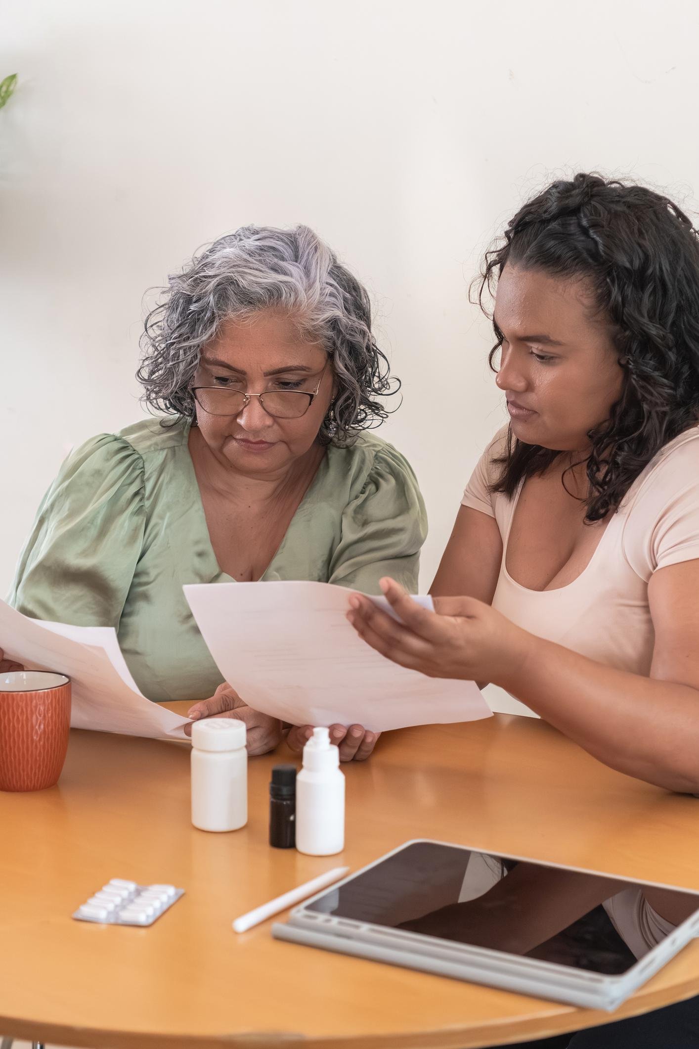 mother and daughter reviewing medical paperwork
