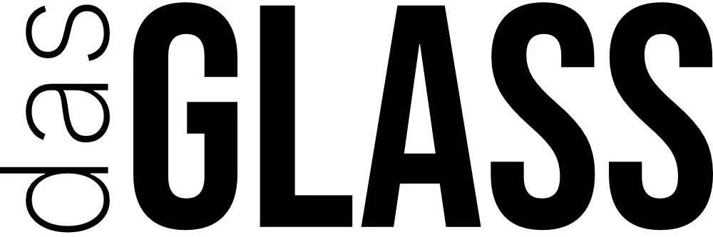 Close-up view of the words 'open glass' written in black text on a white background, with 'open' positioned vertically to the left of 'GLASS'.