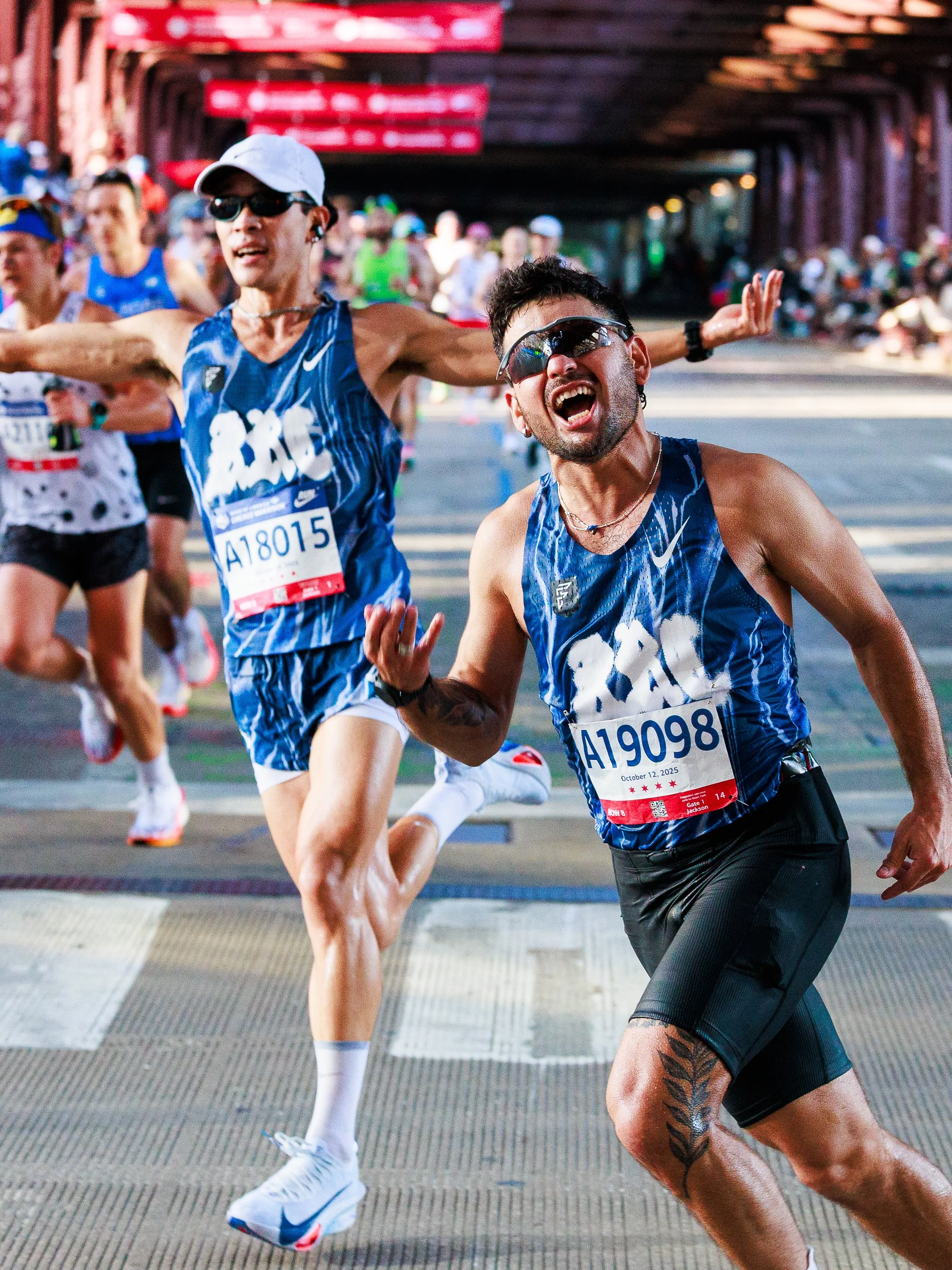 Marathon runners crossing the finish line, celebrating their achievement during the race.