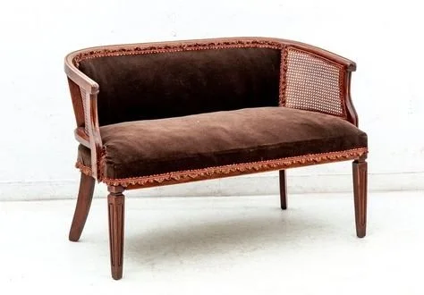 Brown velvet settee with rattan details and trim finishes