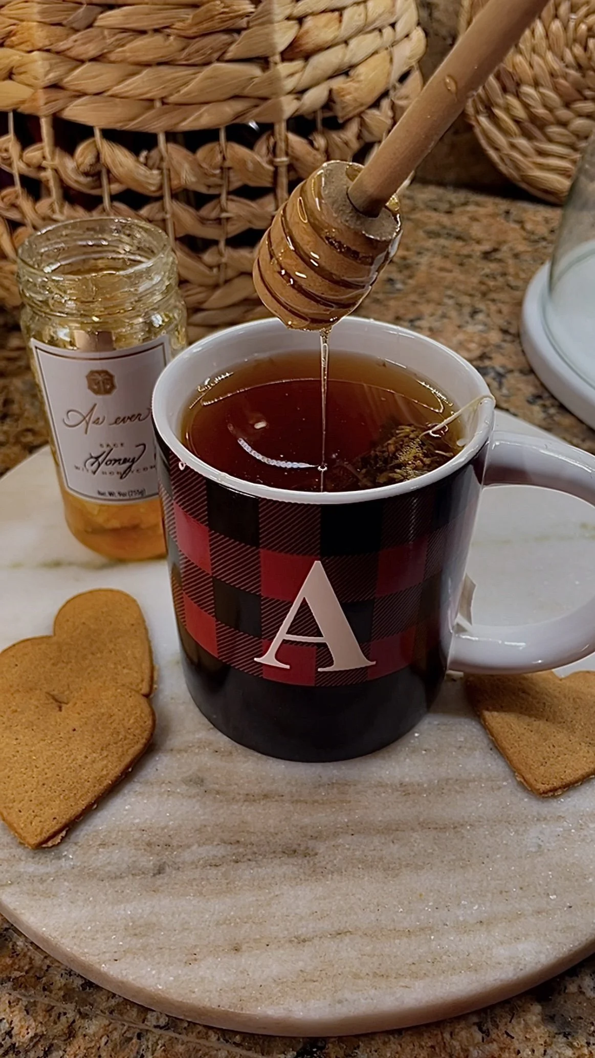 Warm cup of tea with honey drizzling from a wooden dipper, styled for a slow and cozy December moment at home