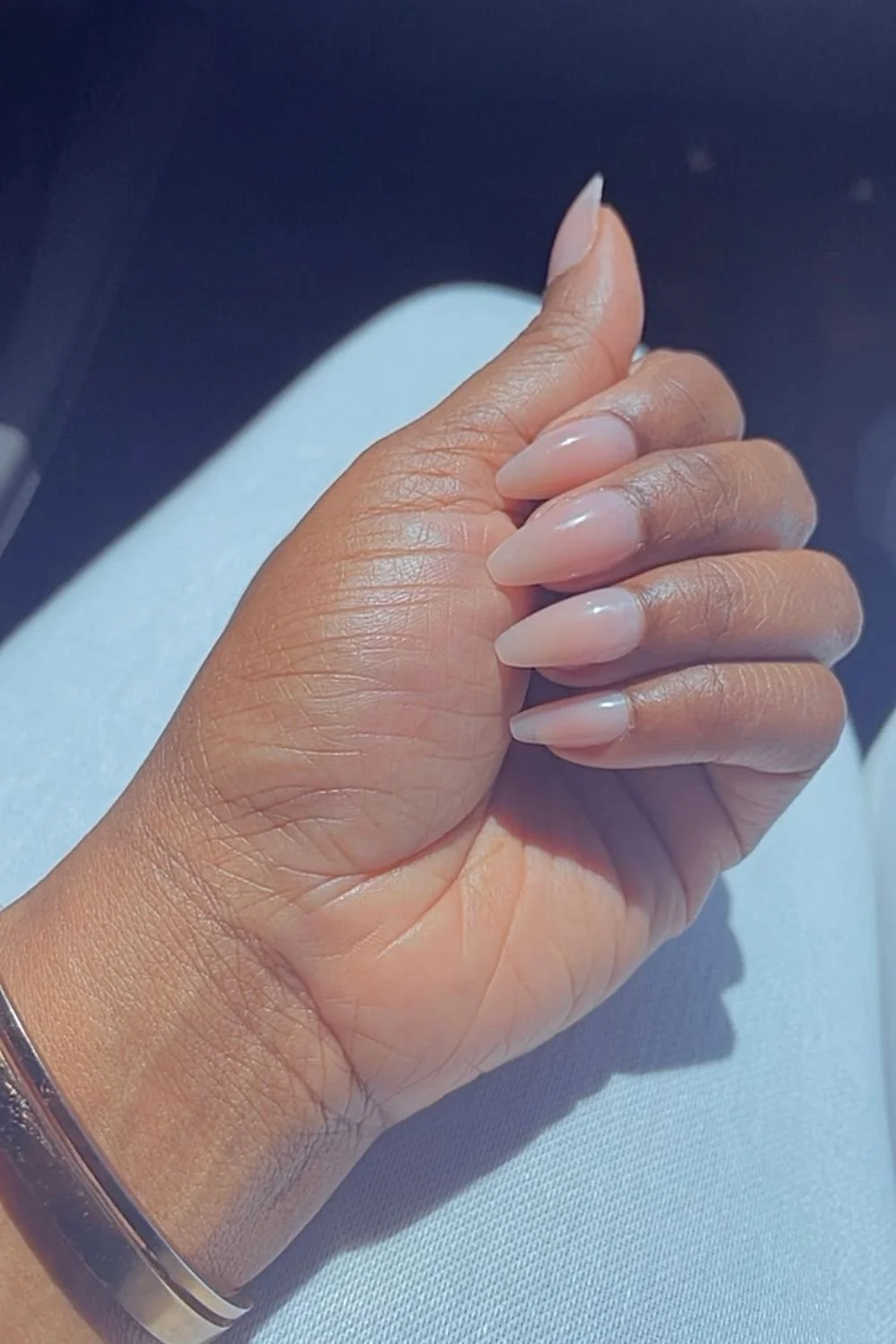 Close-up of almond-shaped press-on nails showing natural finish and clean fit