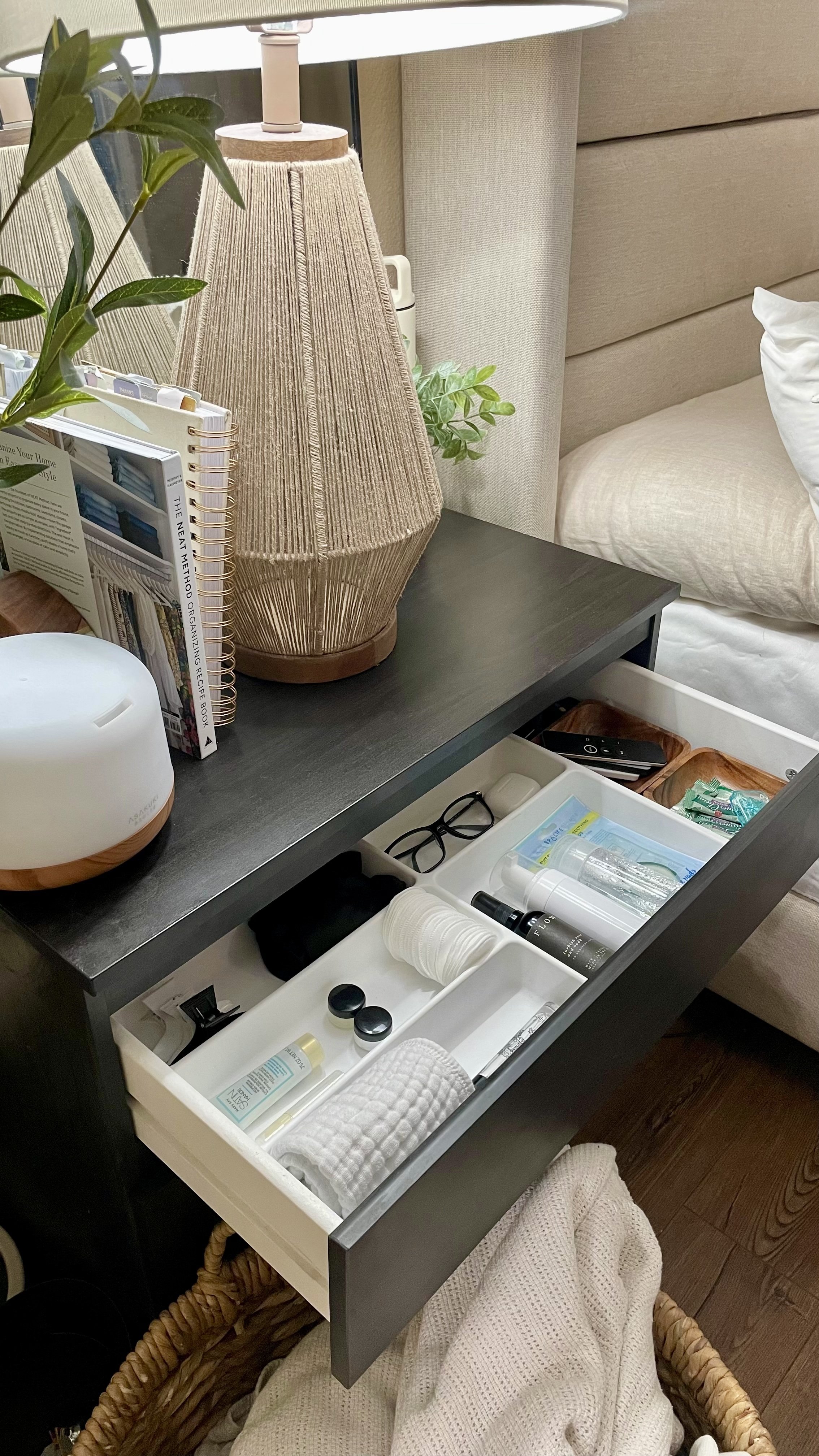 Minimal bedside drawer organization with skincare, eye masks, cotton rounds, and labeled compartments